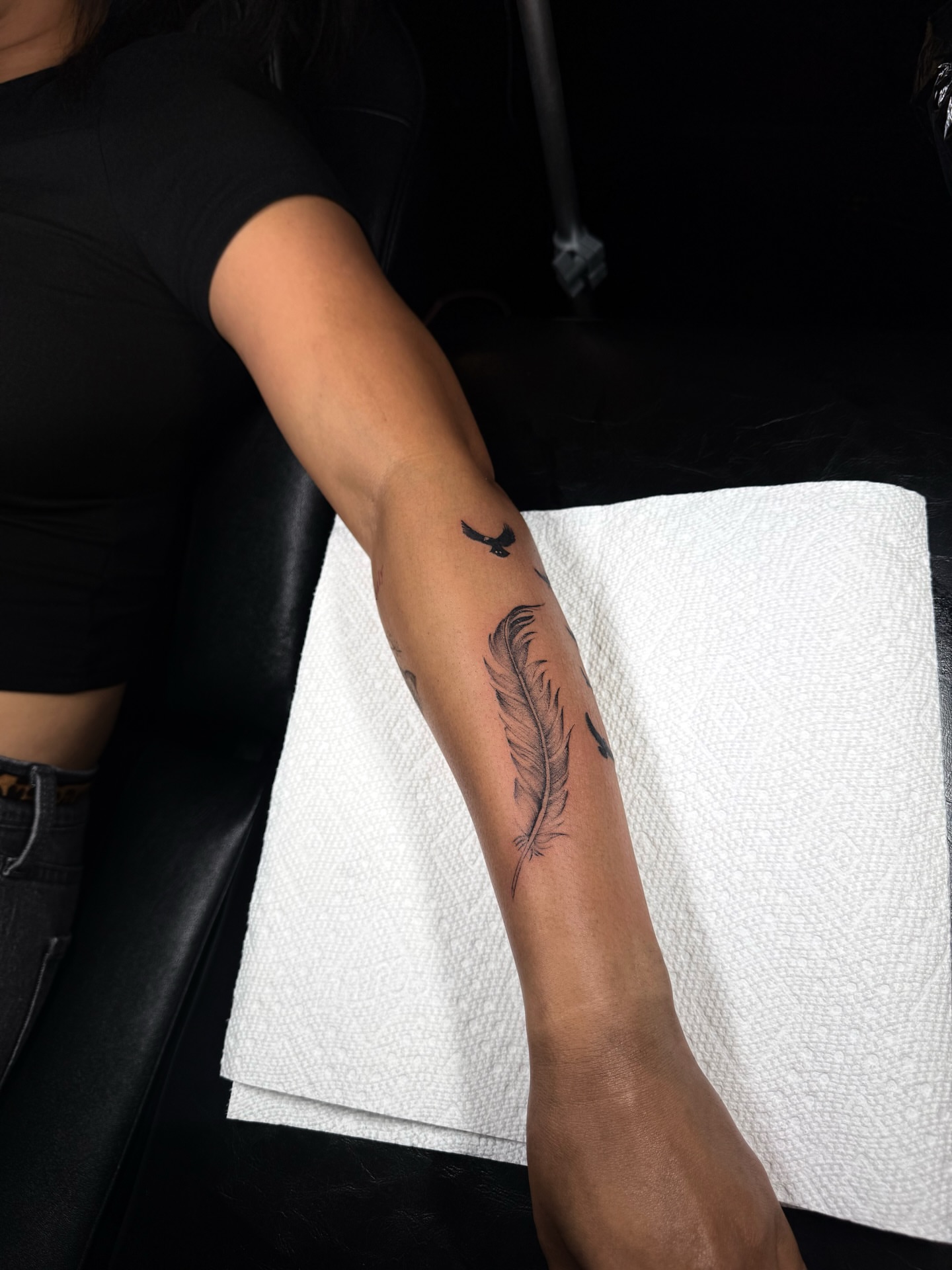 Feather black and grey tattoo on the forearm by ꜰɪɴᴇ ʟɪɴᴇ ᴛᴀᴛᴛᴏᴏꜱ