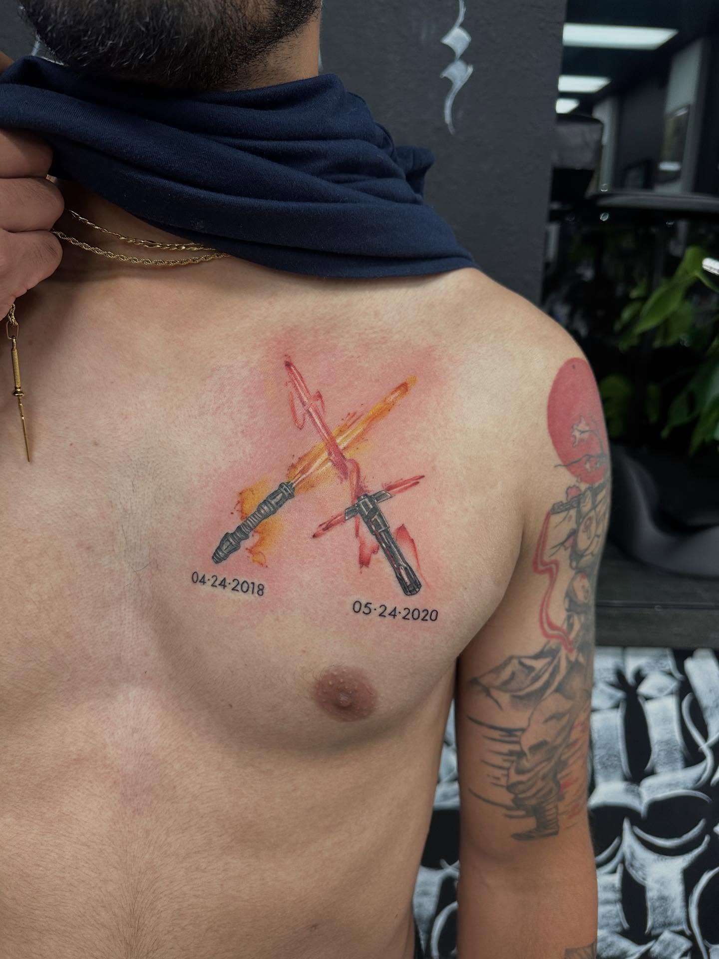 Lightsaber watercolor tattoo on the back by Katrina Aldaco 🧿 Tattoo Artist