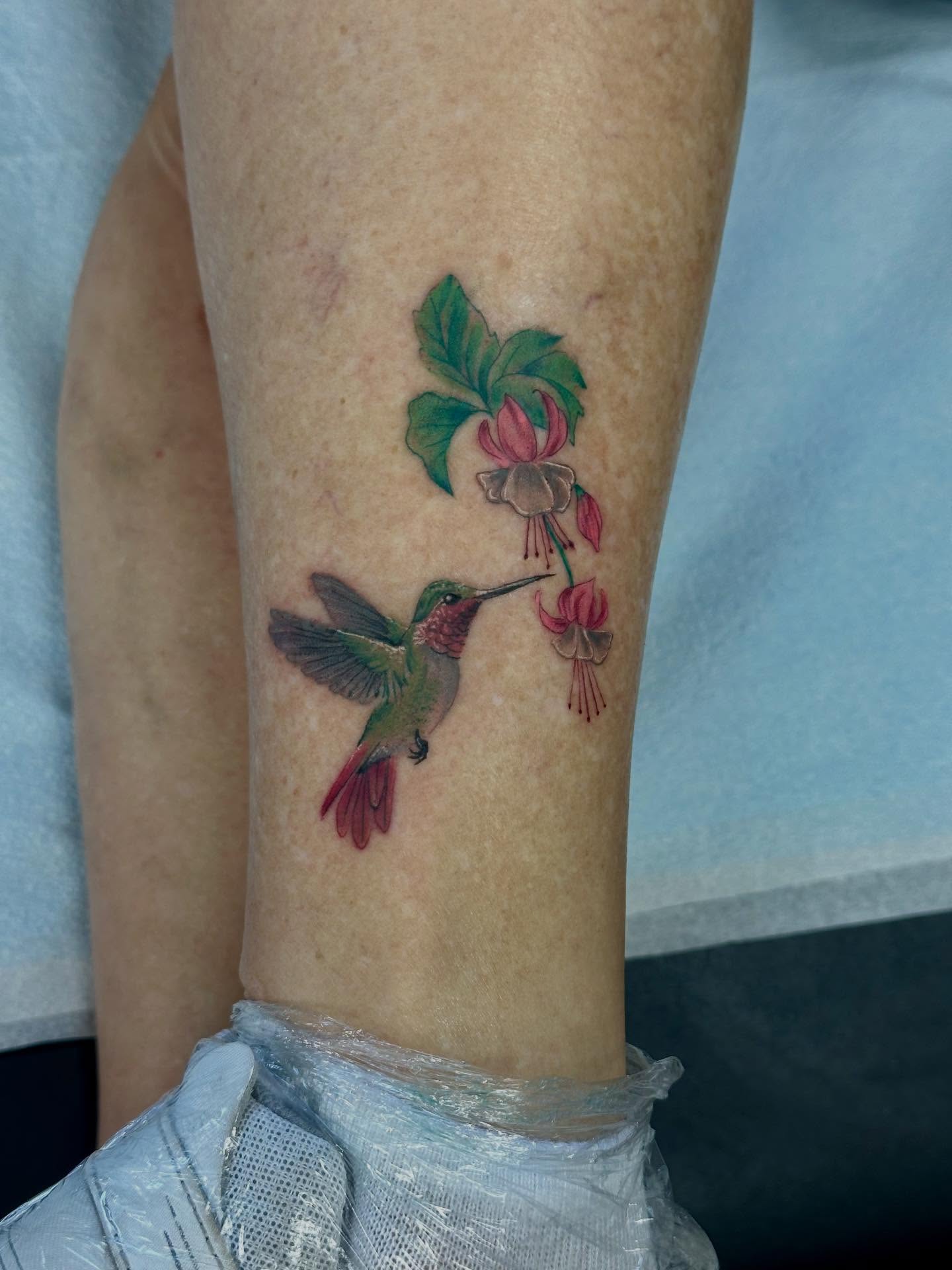 Hummingbird and fuchsia realism tattoo on the forearm by Katrina Aldaco 🧿 Tattoo Artist