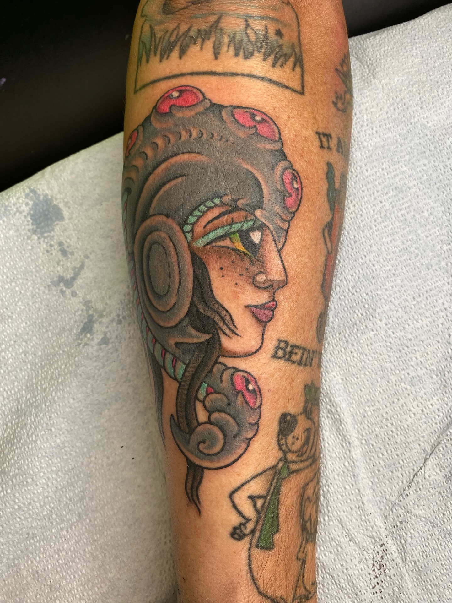Ancient woman American traditional tattoo on the forearm by Mike "Yogi" Trube