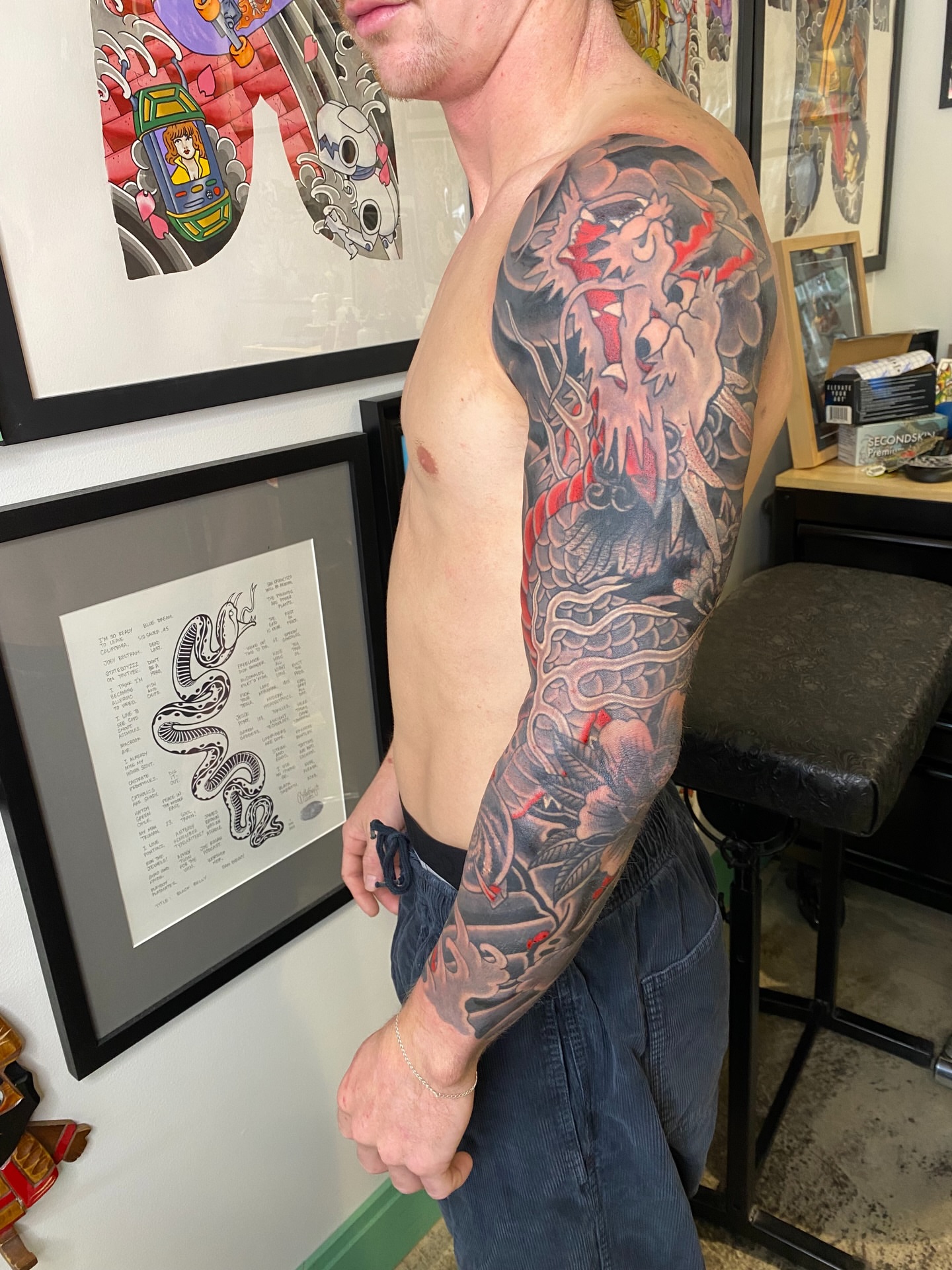 Dragon and flowers japanese irezumi tattoo on the upper arm by Mike "Yogi" Trube