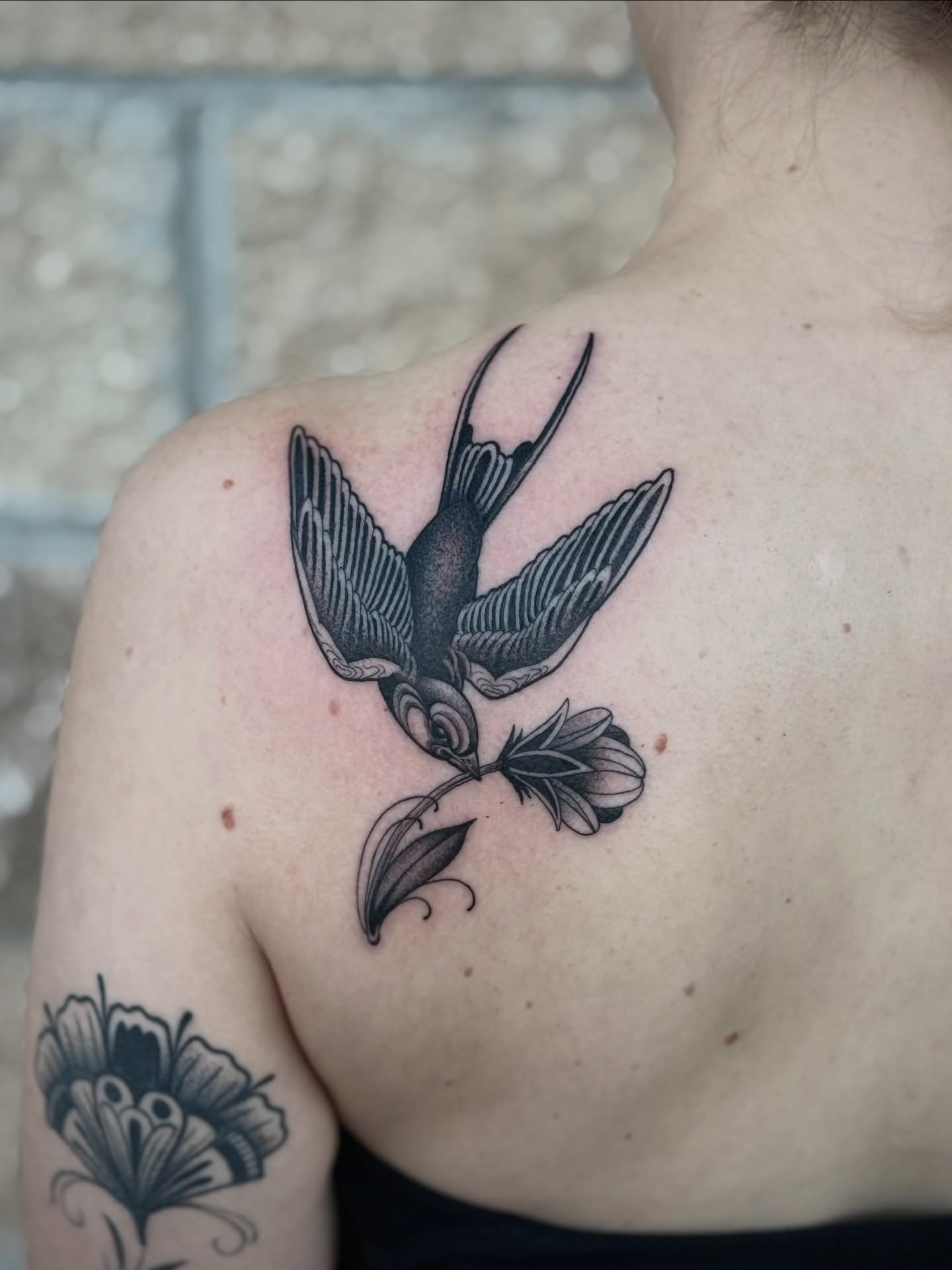 Swallow and flower black and grey tattoo on the shoulder by K9