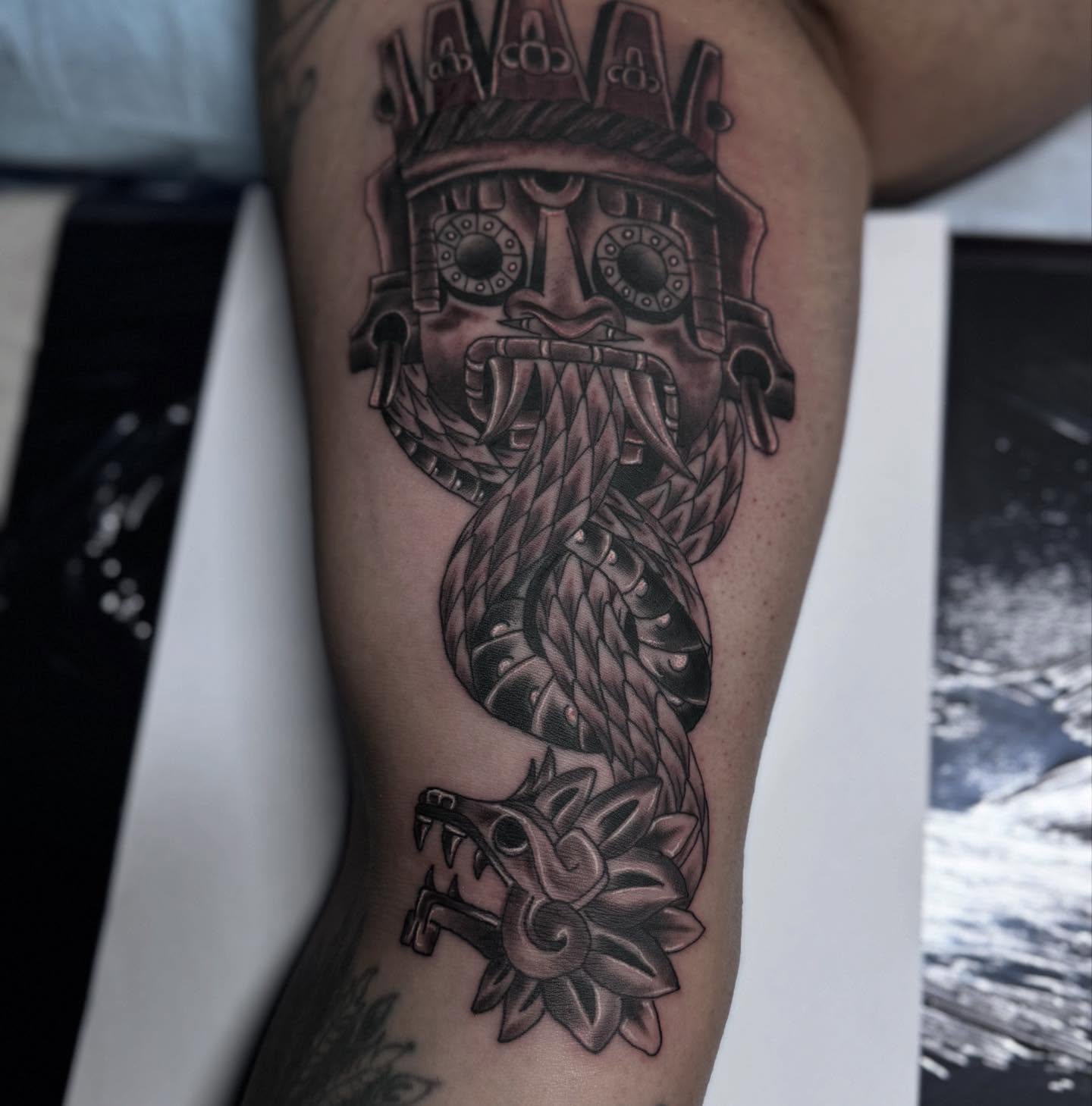 Ancient mask with snake realism tattoo on the forearm by Jacob - Tattoo Artist