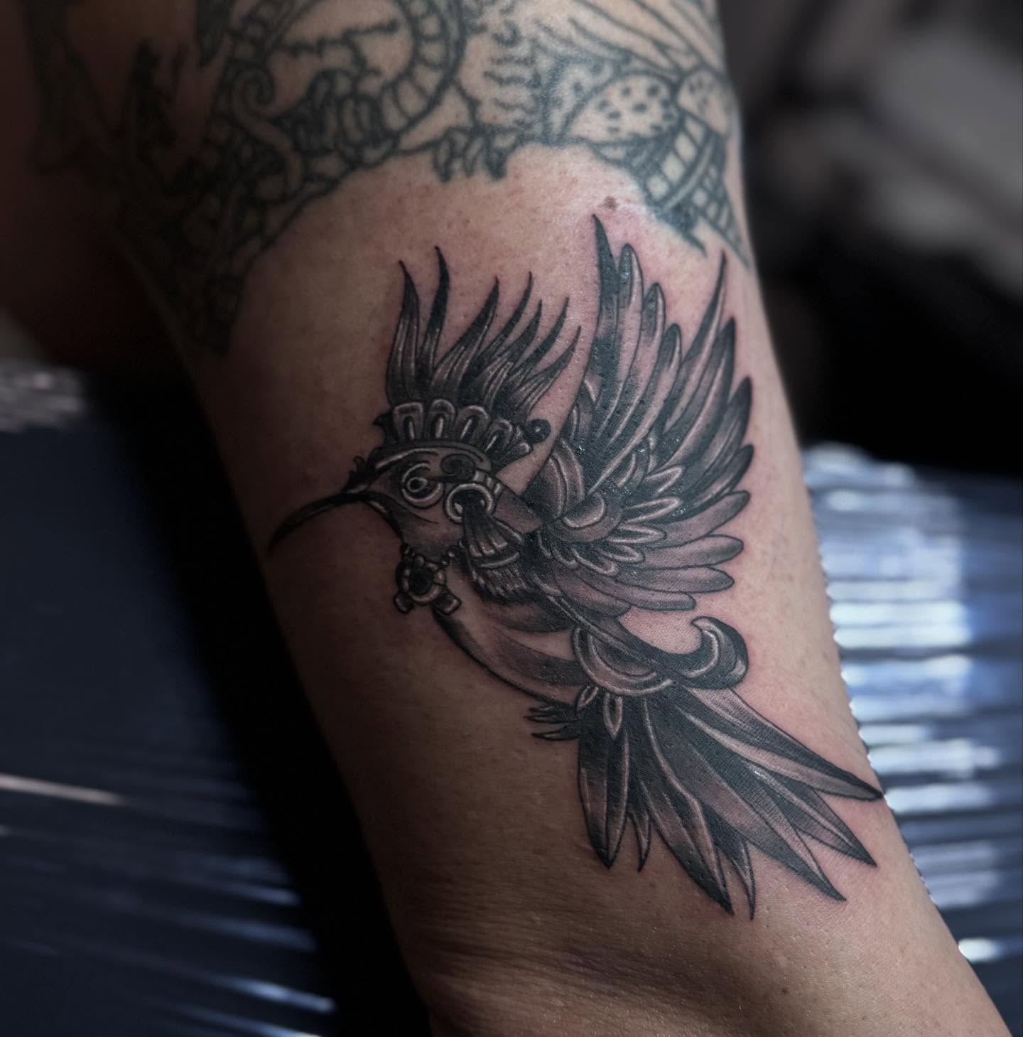 Hummingbird black and grey tattoo on the forearm by Jacob - Tattoo Artist
