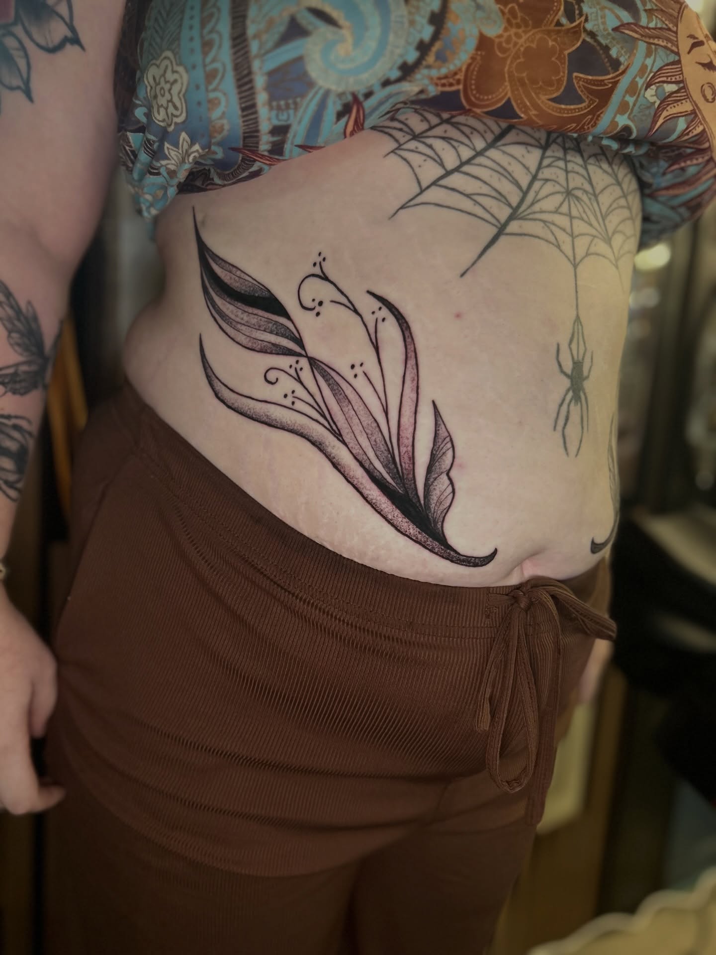 Feather black and grey tattoo on the torso by Torrey, Austin, Texas