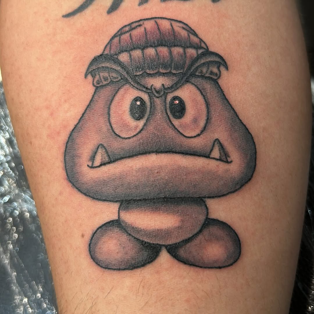Goomba from Super Mario new school tattoo on the thigh by 🇬🇹