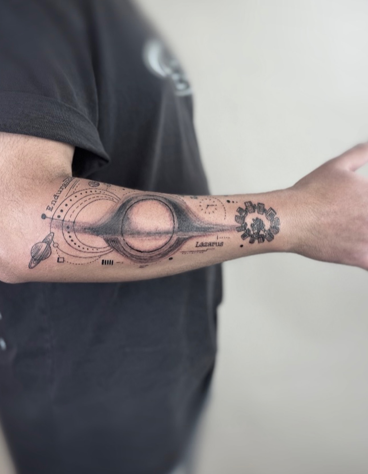 Space-themed design geometric tattoo on the forearm by Jadyn Pang