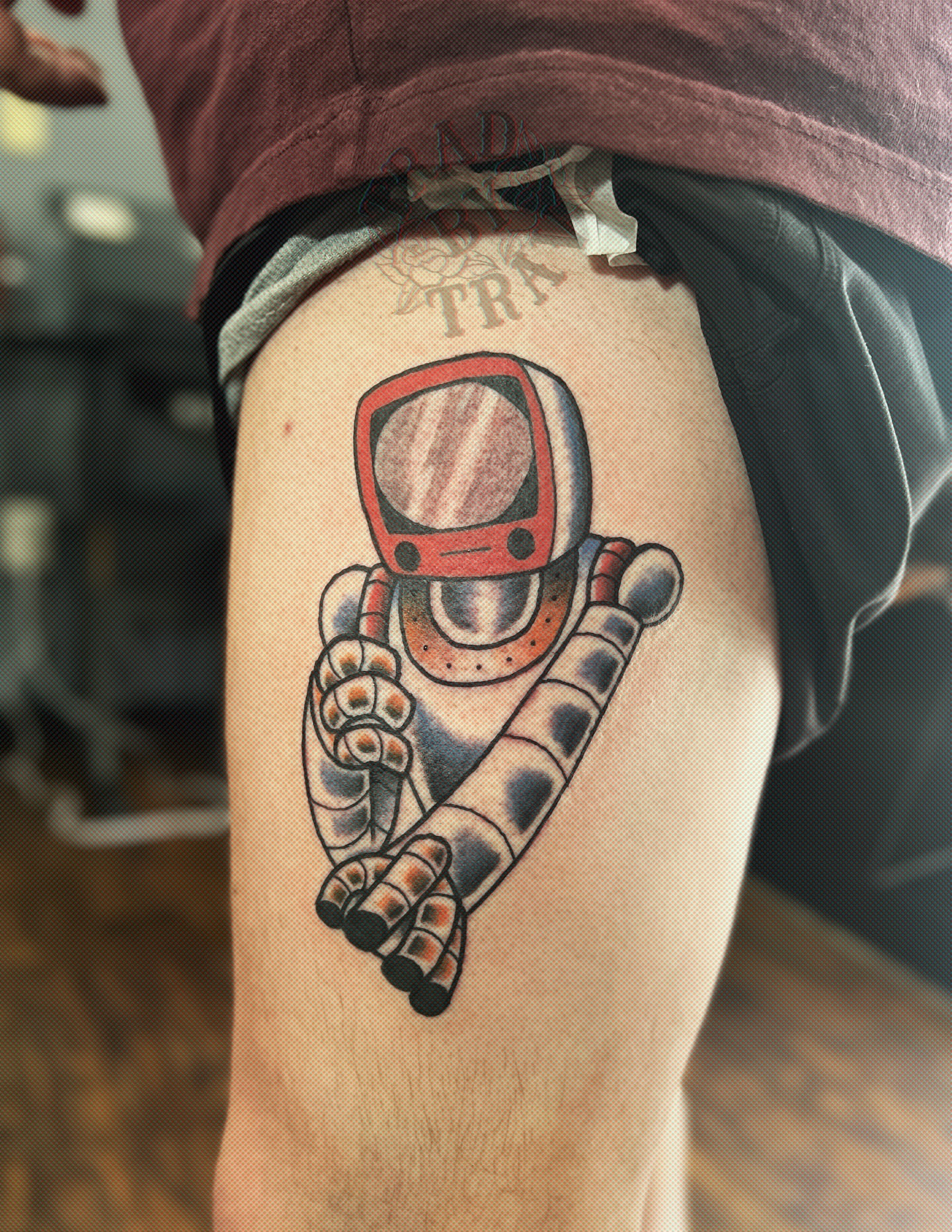 Robot astronaut American traditional tattoo on the thigh by Travis B