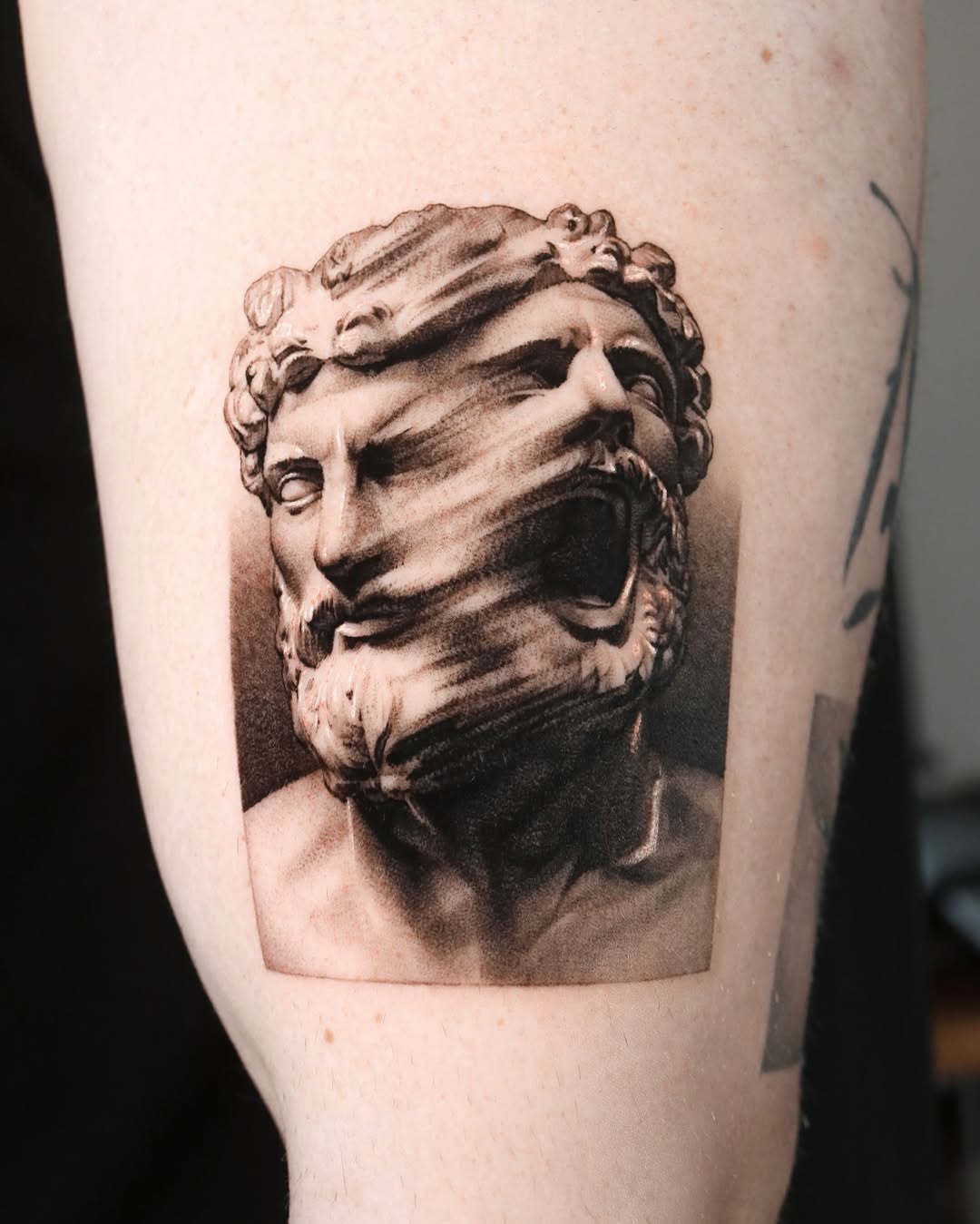 Distorted classical bust surrealism tattoo on the forearm by Saru