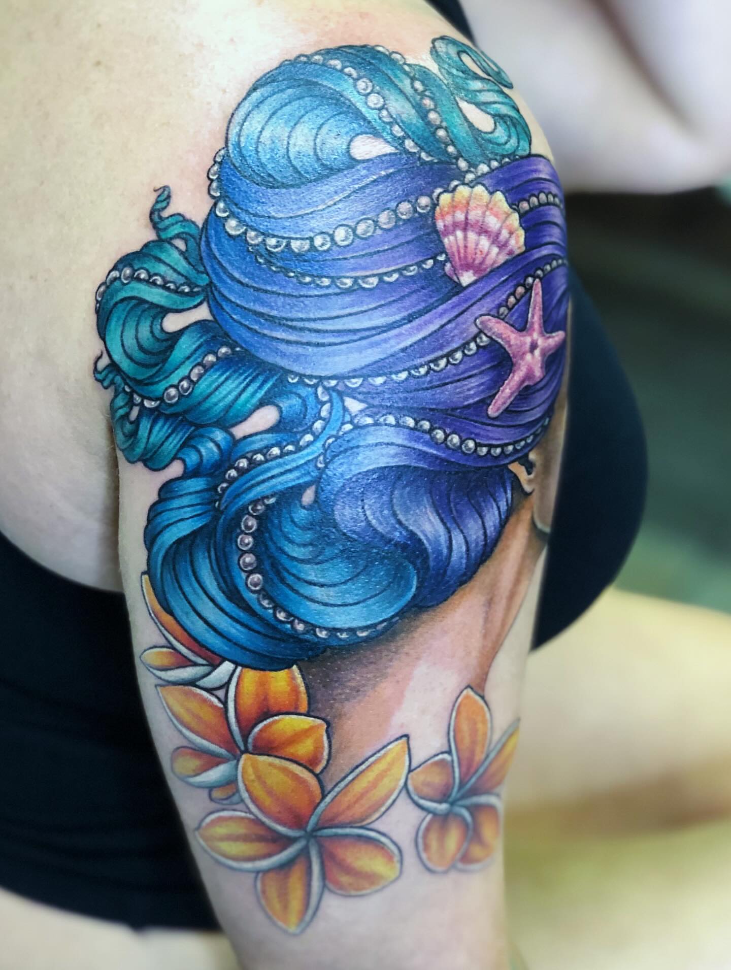 Octopus and flowers new school tattoo on the forearm by Teddi Bird