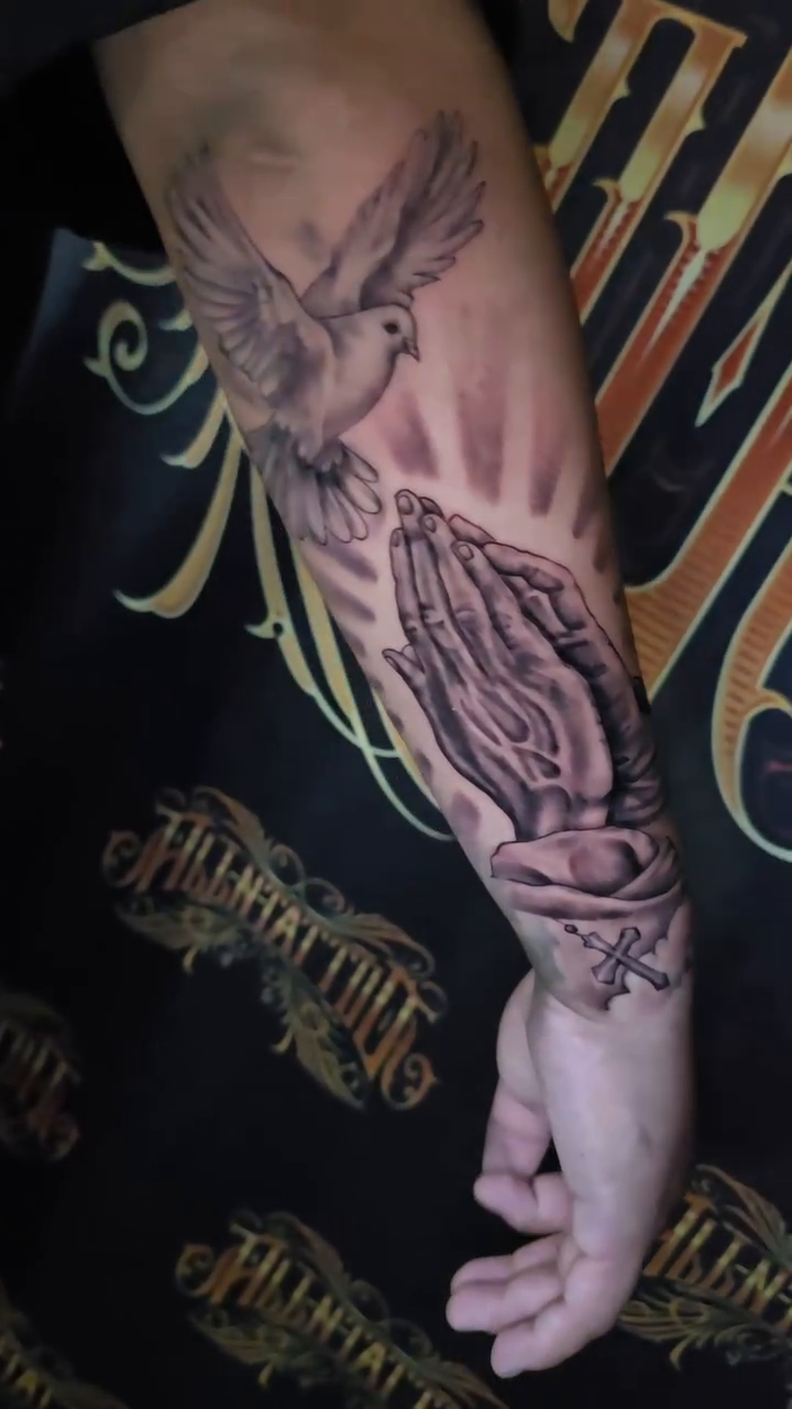 Praying hands and dove realism tattoo by Jesse James, Las Vegas, Nevada