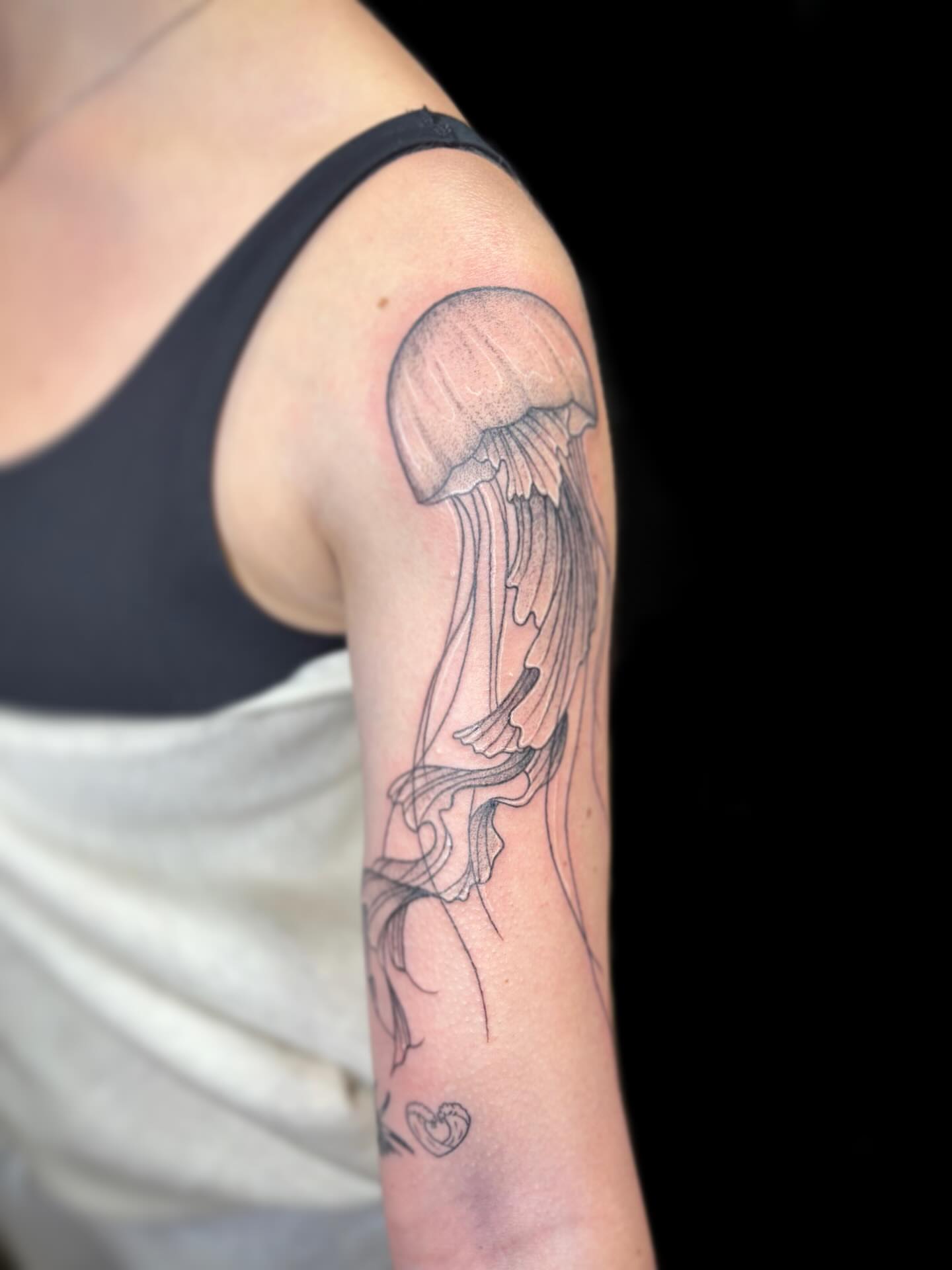 Jellyfish black and grey tattoo on the upper arm by Ashtyn ☾