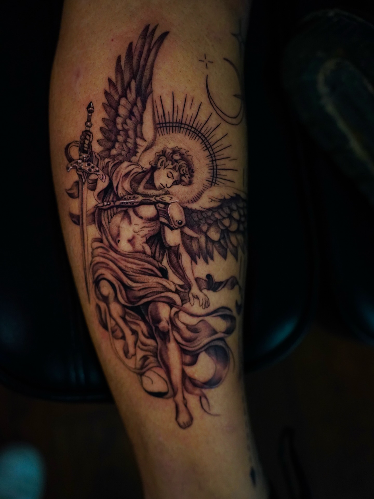 Angel with sword black and grey tattoo on the forearm by Dallas Tattoo Artist