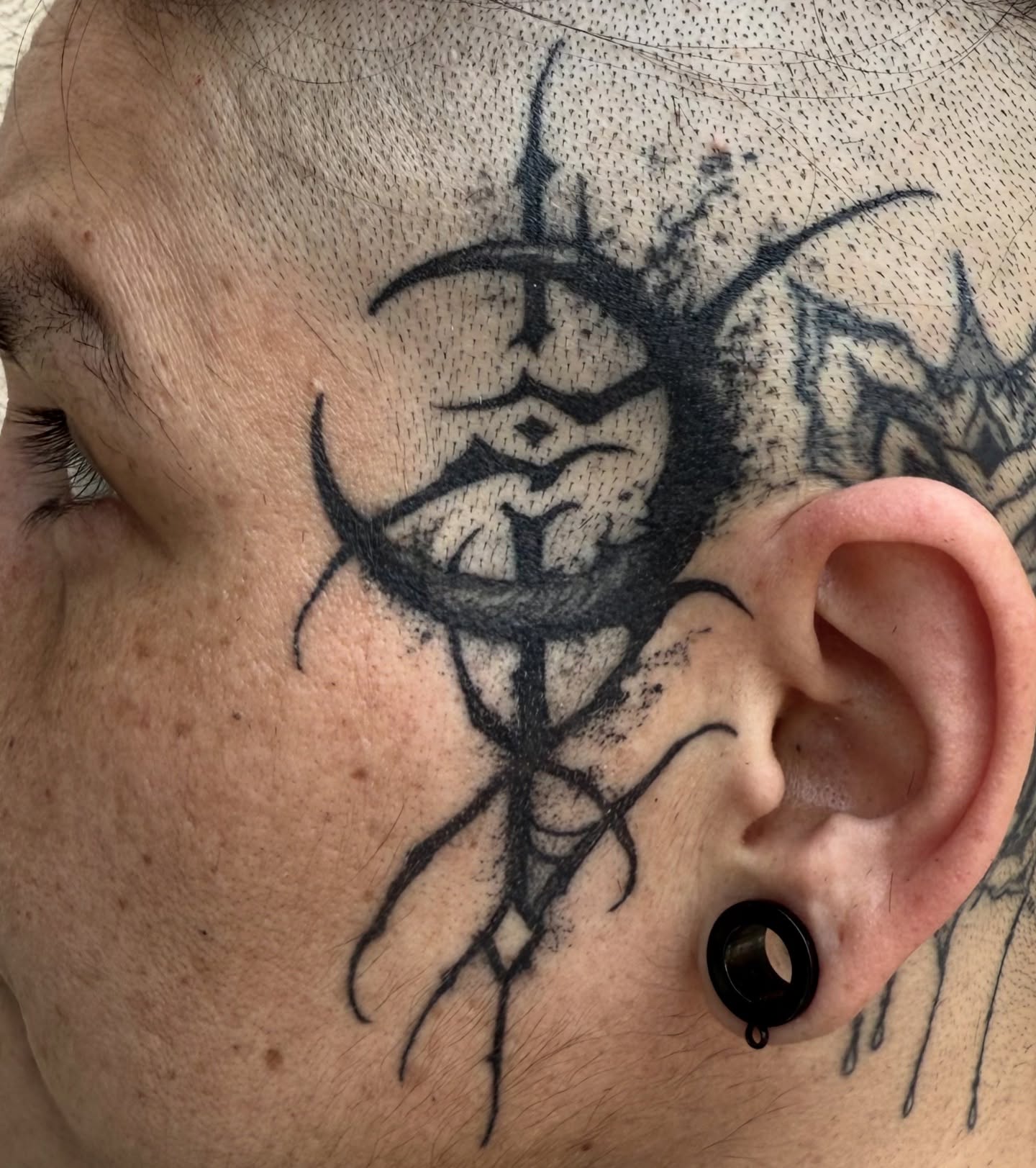 Thorned mask black and grey tattoo on the neck by Jamie