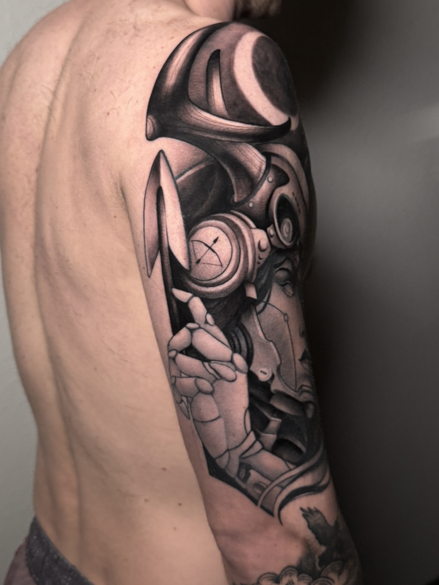 Mechanical figure geometric tattoo on the upper arm by Carlos Valdes ✨ Tattoo Artist in Tampa FL