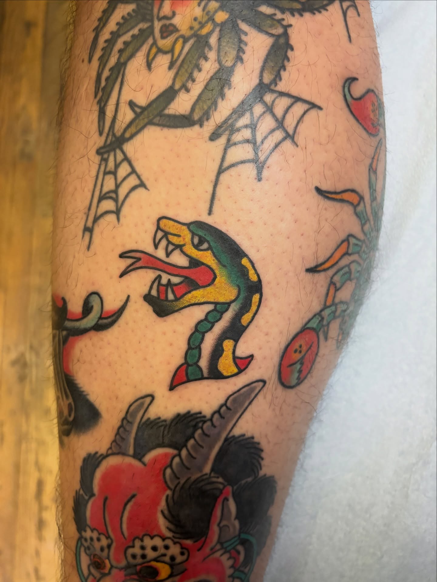 Snake American traditional tattoo on the forearm by Cooper Reichwein