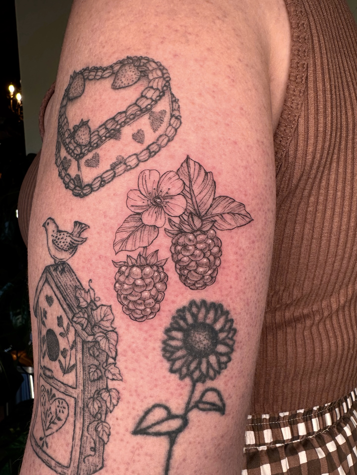 Berries and flowers black and grey tattoo on the forearm by kenzie hunter