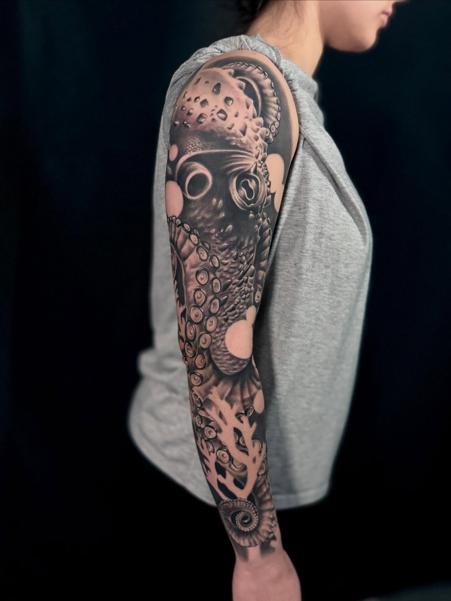 Octopus realism tattoo on the upper arm by Cody Pappas