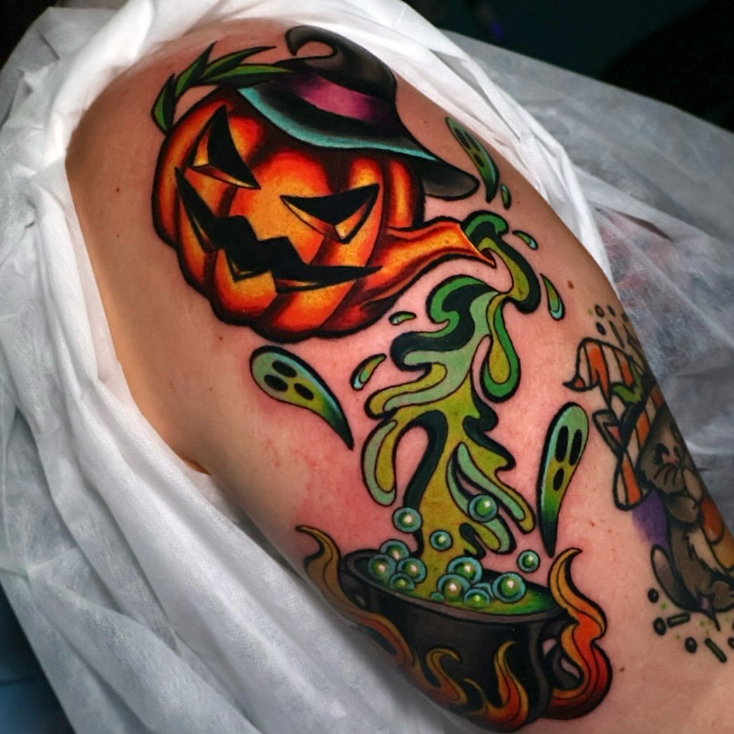 Pumpkin and cauldron American traditional tattoo on the shoulder by Bailey Drey