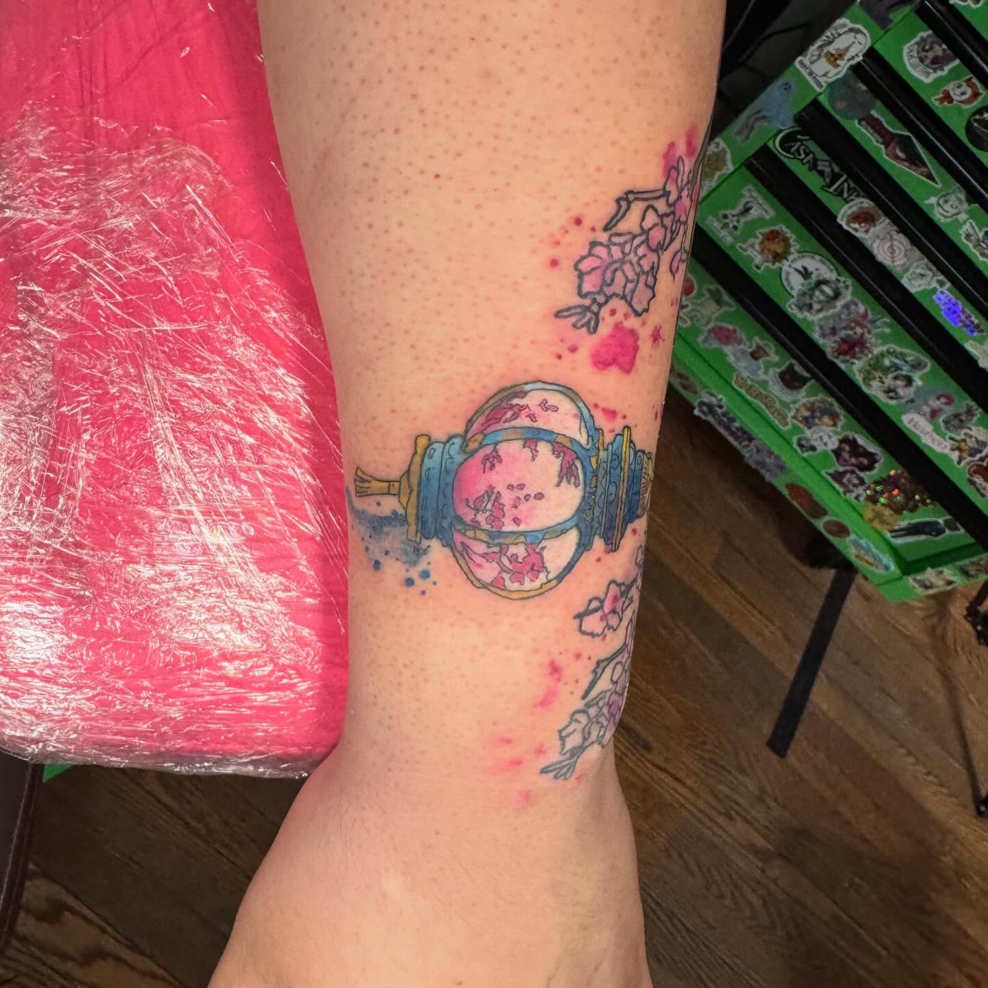 Lantern and cherry blossoms watercolor tattoo on the forearm by Paula.p.tattoos