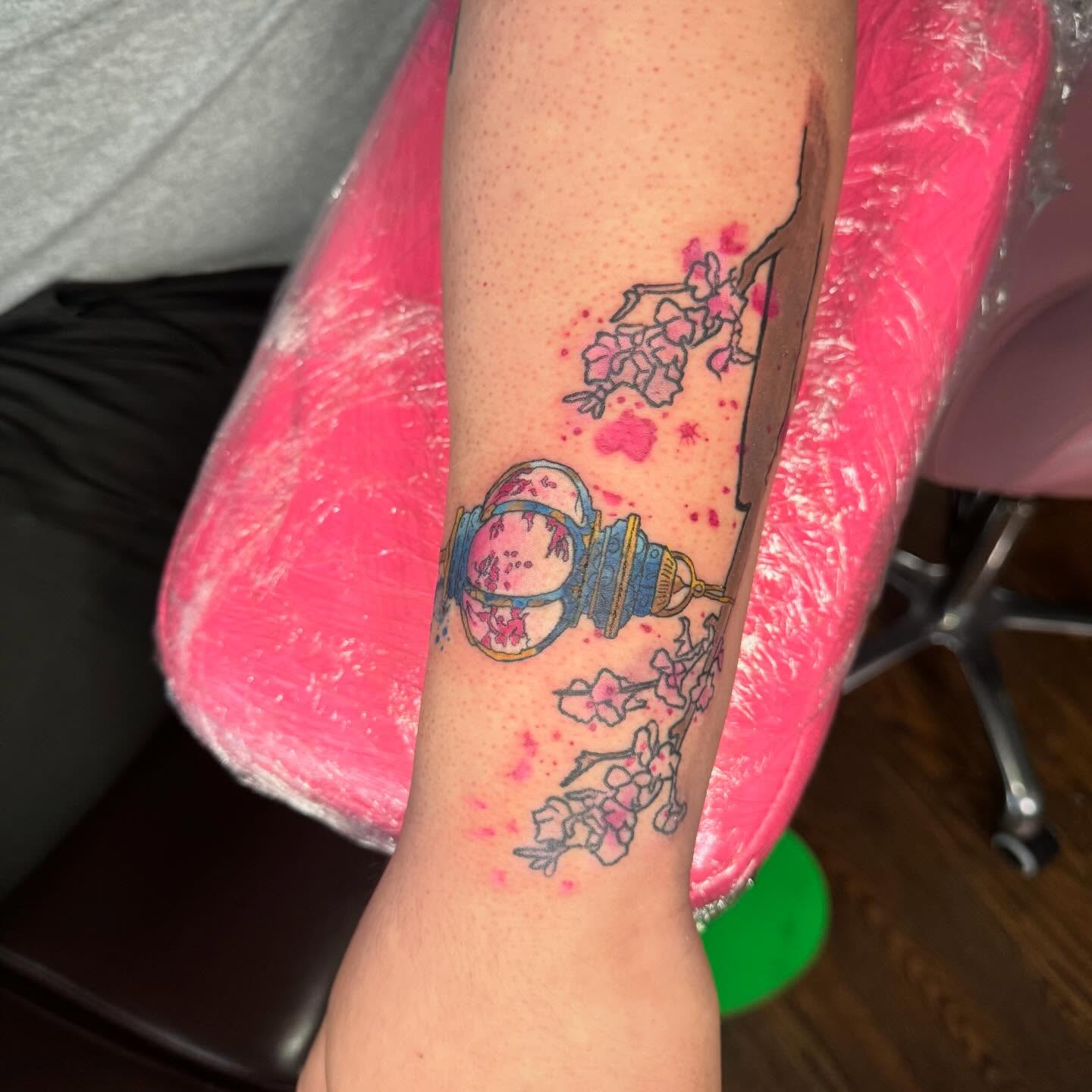 Cherry blossom and lantern watercolor tattoo on the forearm by Paula.p.tattoos