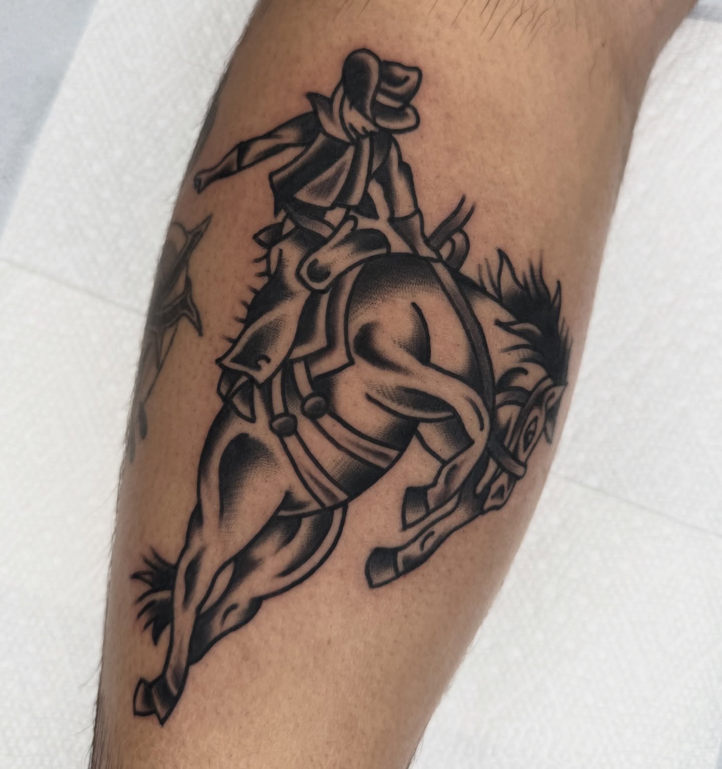 Cowboy riding horse black and grey tattoo on the forearm by Drew🕸️, Phoenix, Arizona