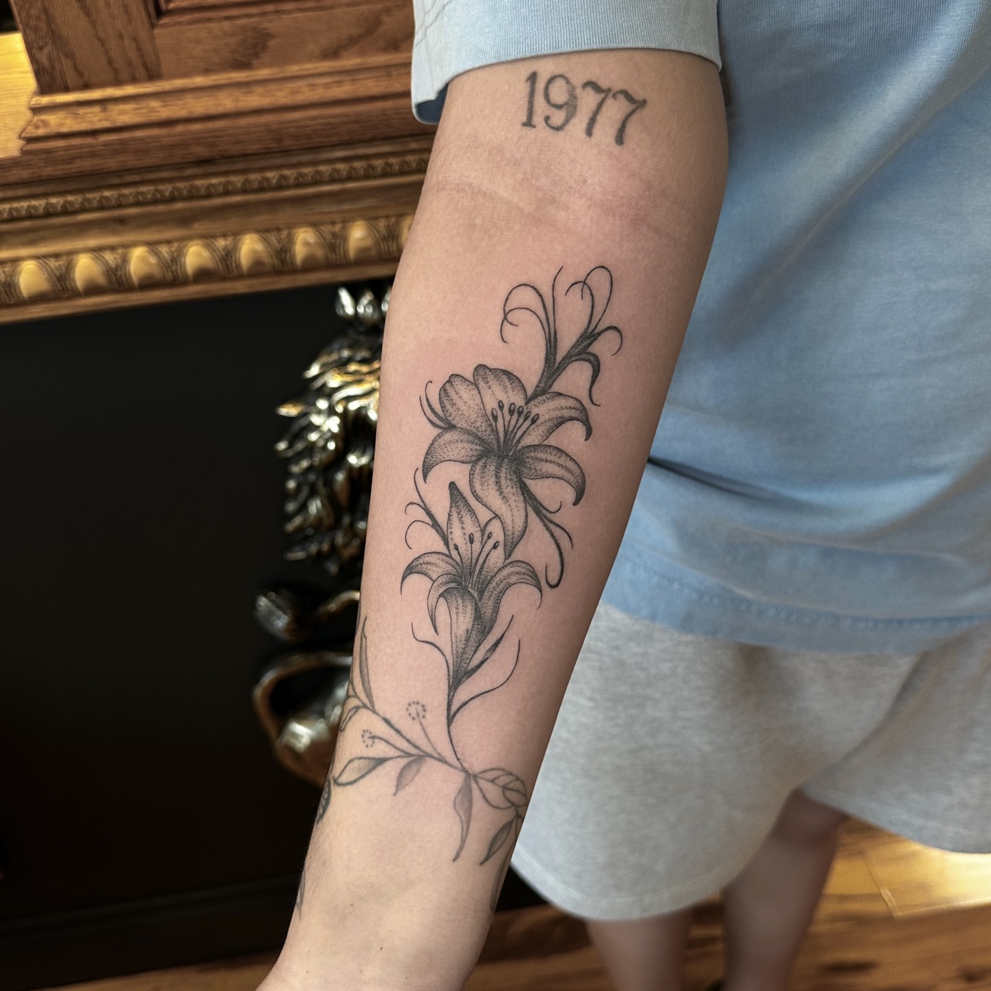 Lilies black and grey tattoo on the forearm by Leo Fernandes, Danvers, Massachusetts