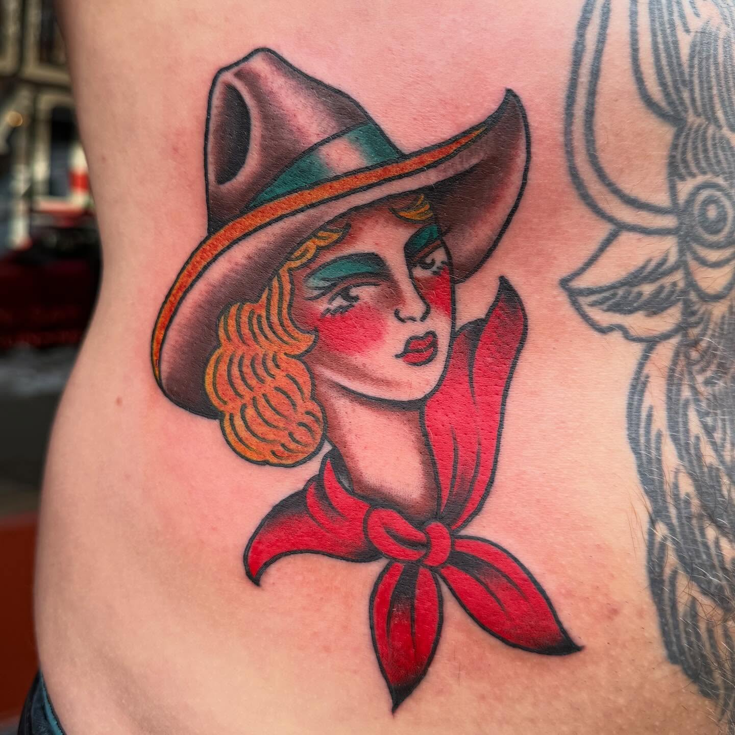 Cowgirl American traditional tattoo on the thigh by Zach Roman, Madison, Wisconsin