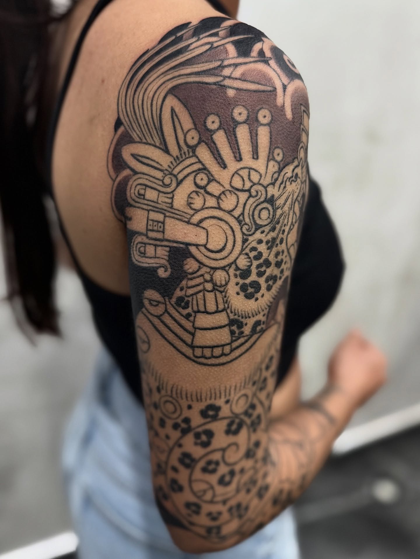 Mexican deity geometric tattoo on the forearm by Meza Cruz