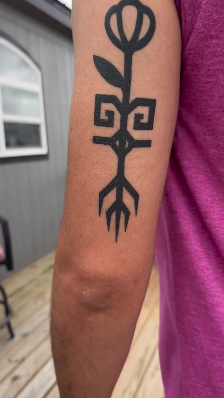 Stylized flower and root symbol blackwork tattoo by ๐ฎ๐๐๐๐๐๐