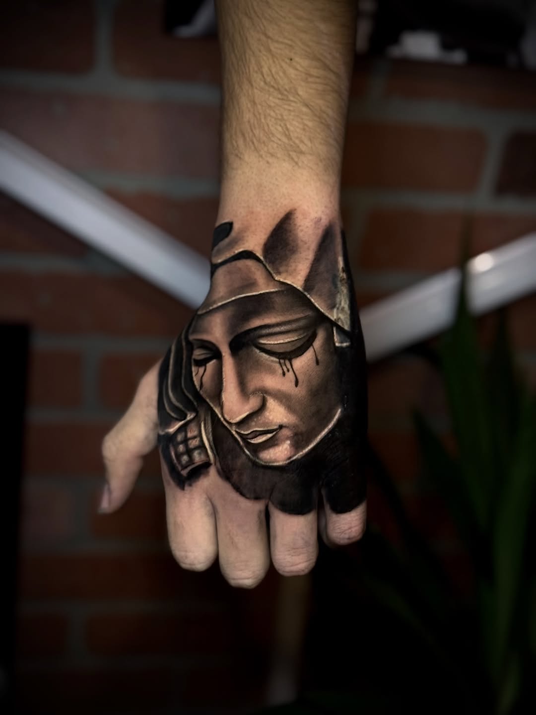 Statue face Chicano tattoo on the hand by Andres Calvo🇺🇸🇨🇴