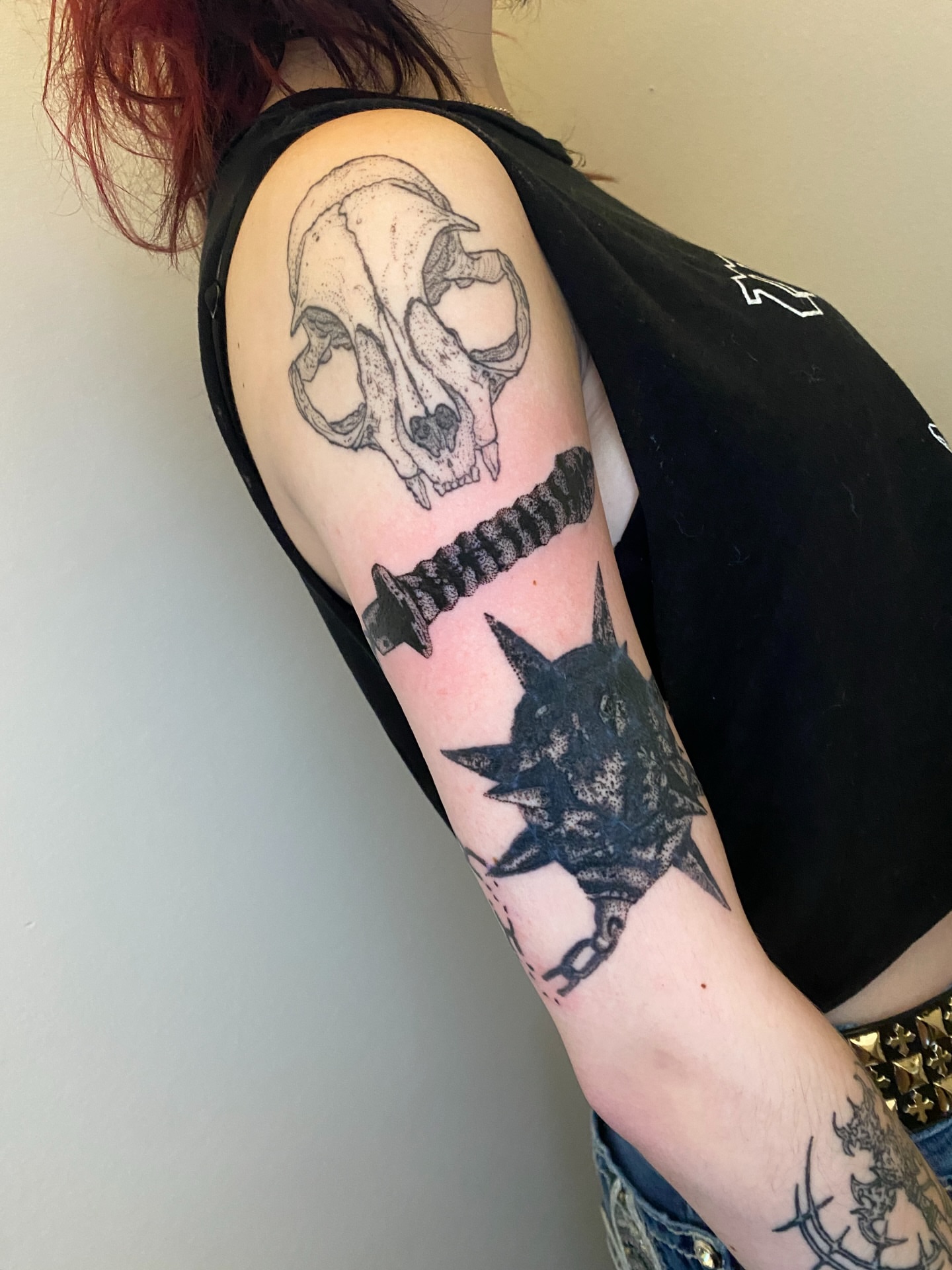 Skull and sword geometric tattoo on the upper arm by Aidan Leery, Portland, Oregon