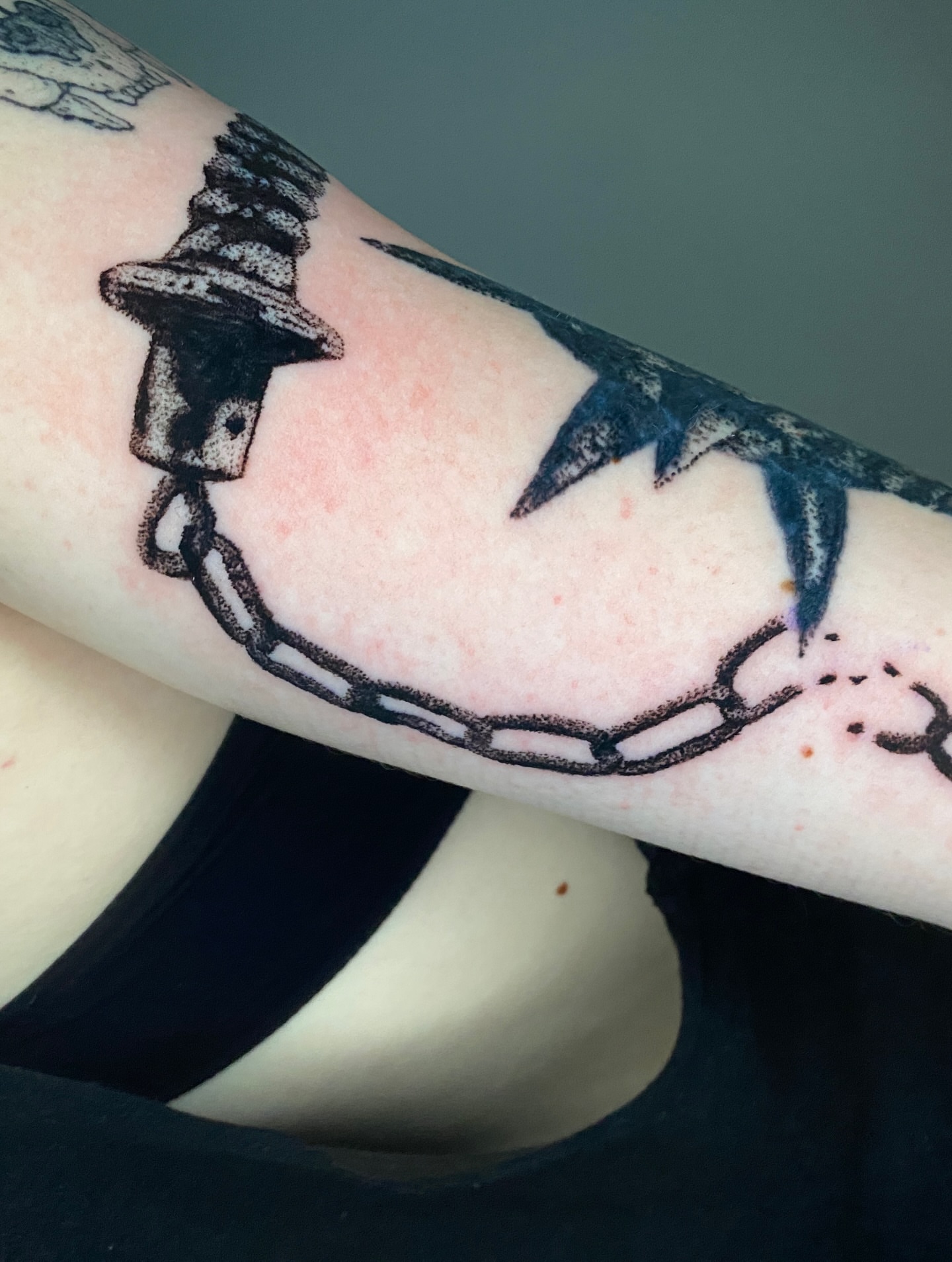 Barbed wire and chain black and grey tattoo on the forearm by Aidan Leery, Portland, Oregon