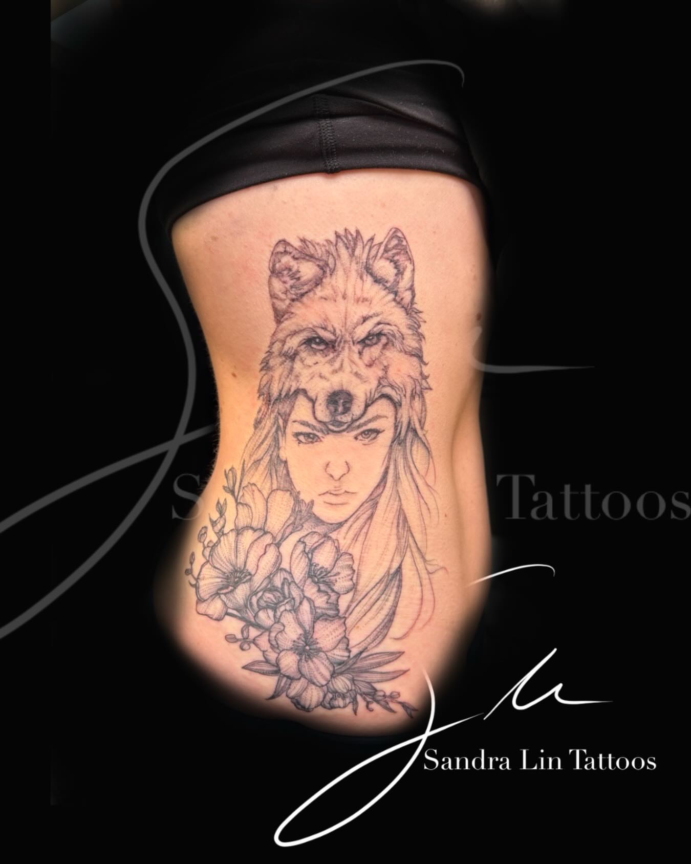 Wolf and woman realism tattoo on the ribs by Sandra Lin Cue