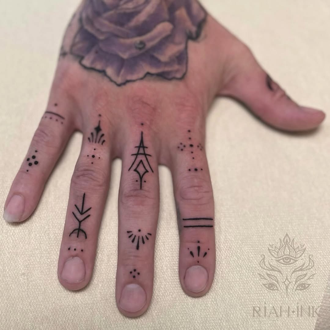 Geometric symbols and dots ornamental tattoo on the hand by Nils Bashirian