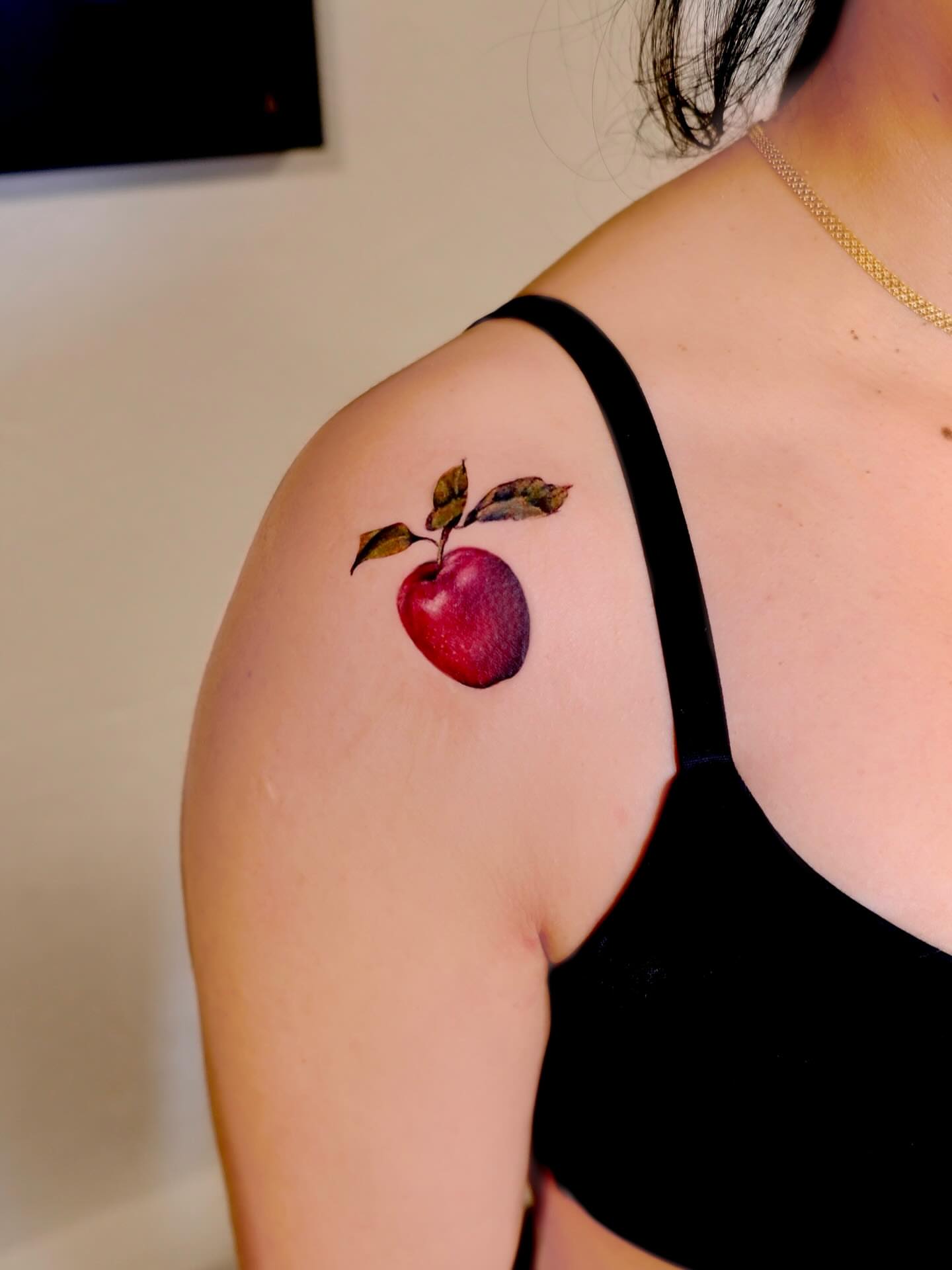 Apple realism tattoo on the shoulder by Thin line and color TATTOO.