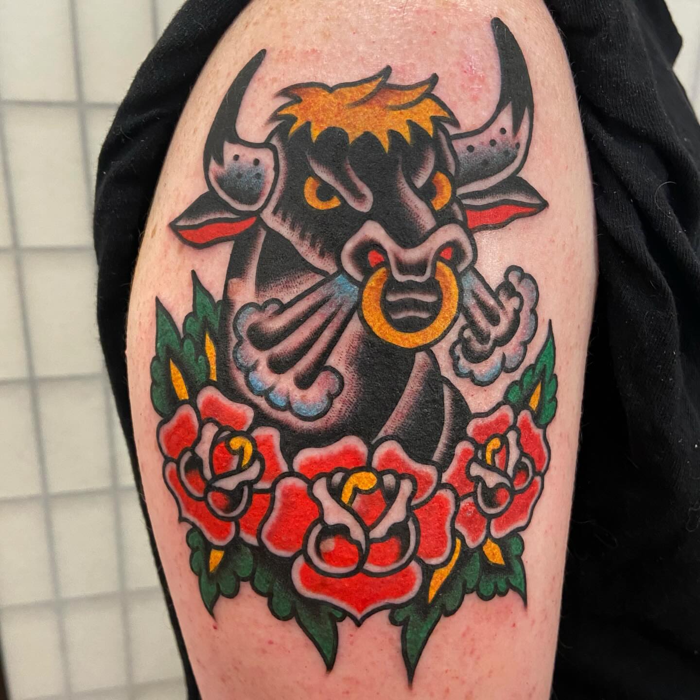 Bull and roses American traditional tattoo on the forearm by Anthony Jaeger, Seattle, Washington