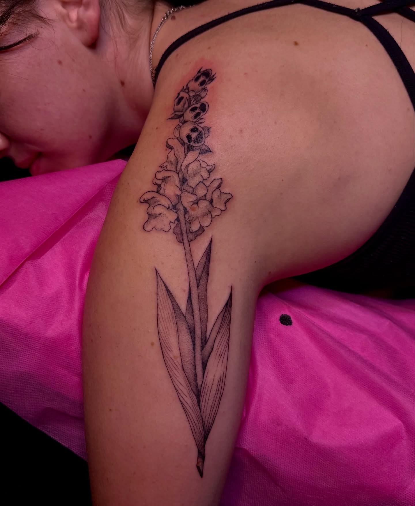 Gladiolus flower black and grey tattoo on the upper arm by ✧Lee Ortiz