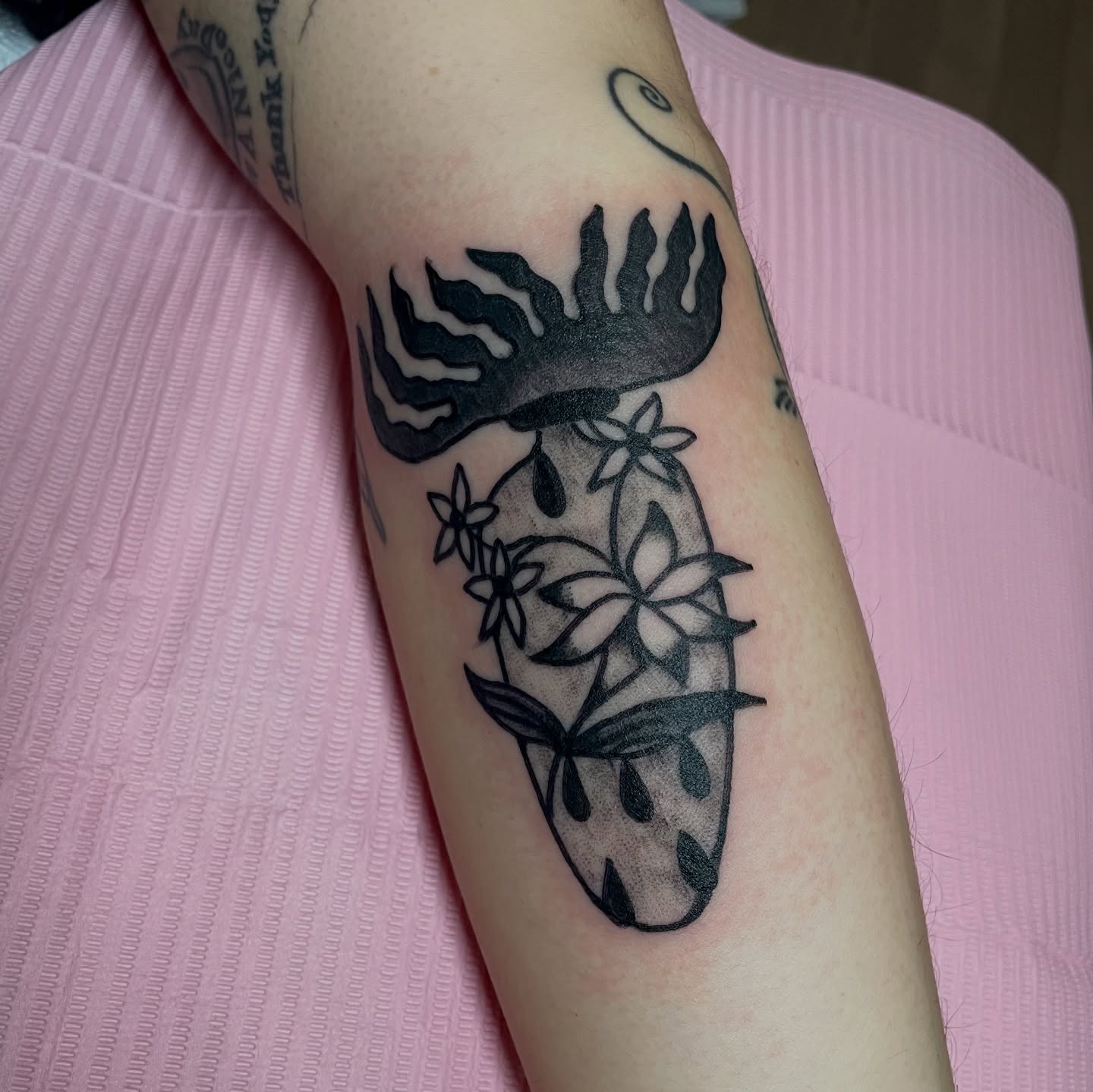 Flame and flowers black and grey tattoo on the forearm by zoe ๐