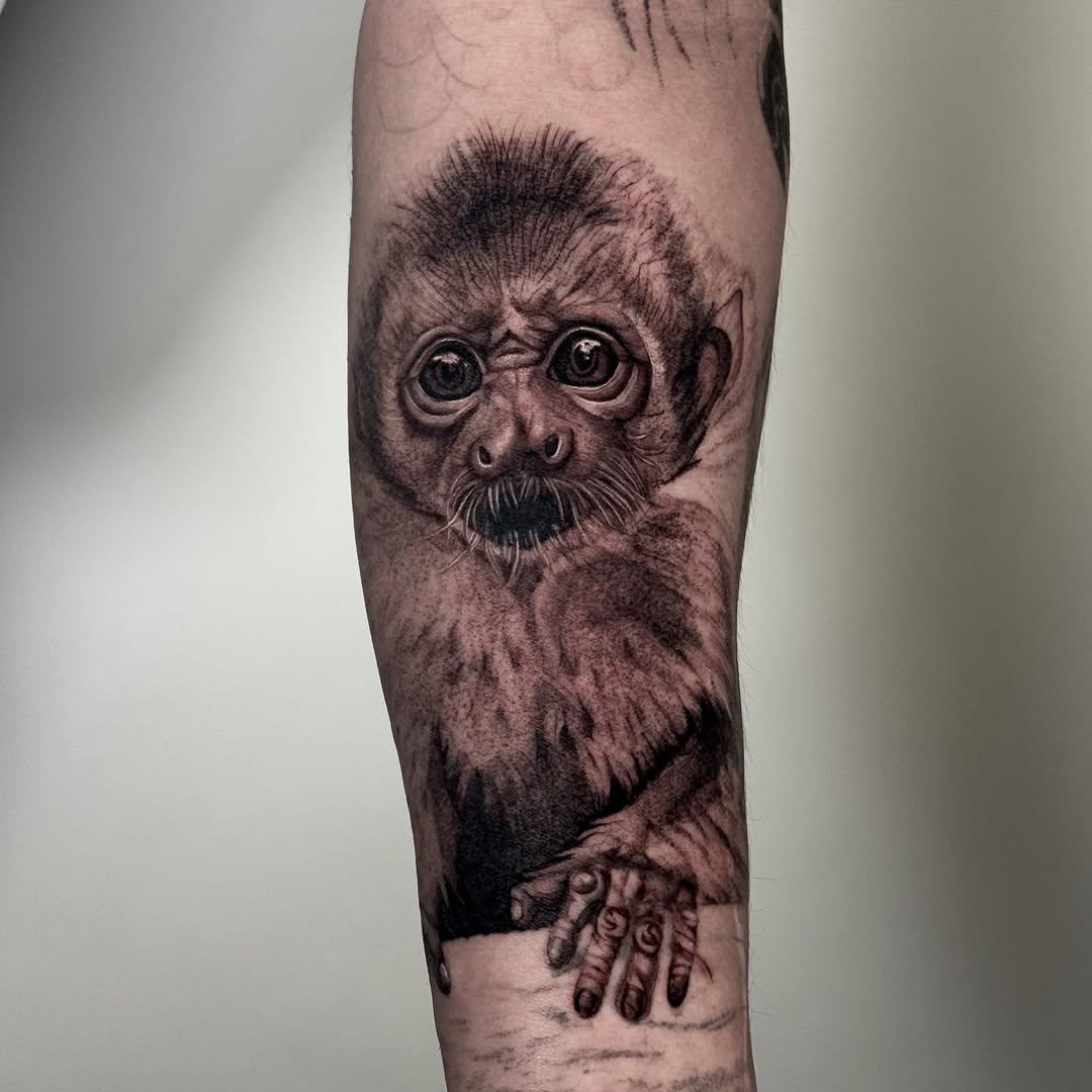Baby monkey realism tattoo on the forearm by Brisia Cisneros