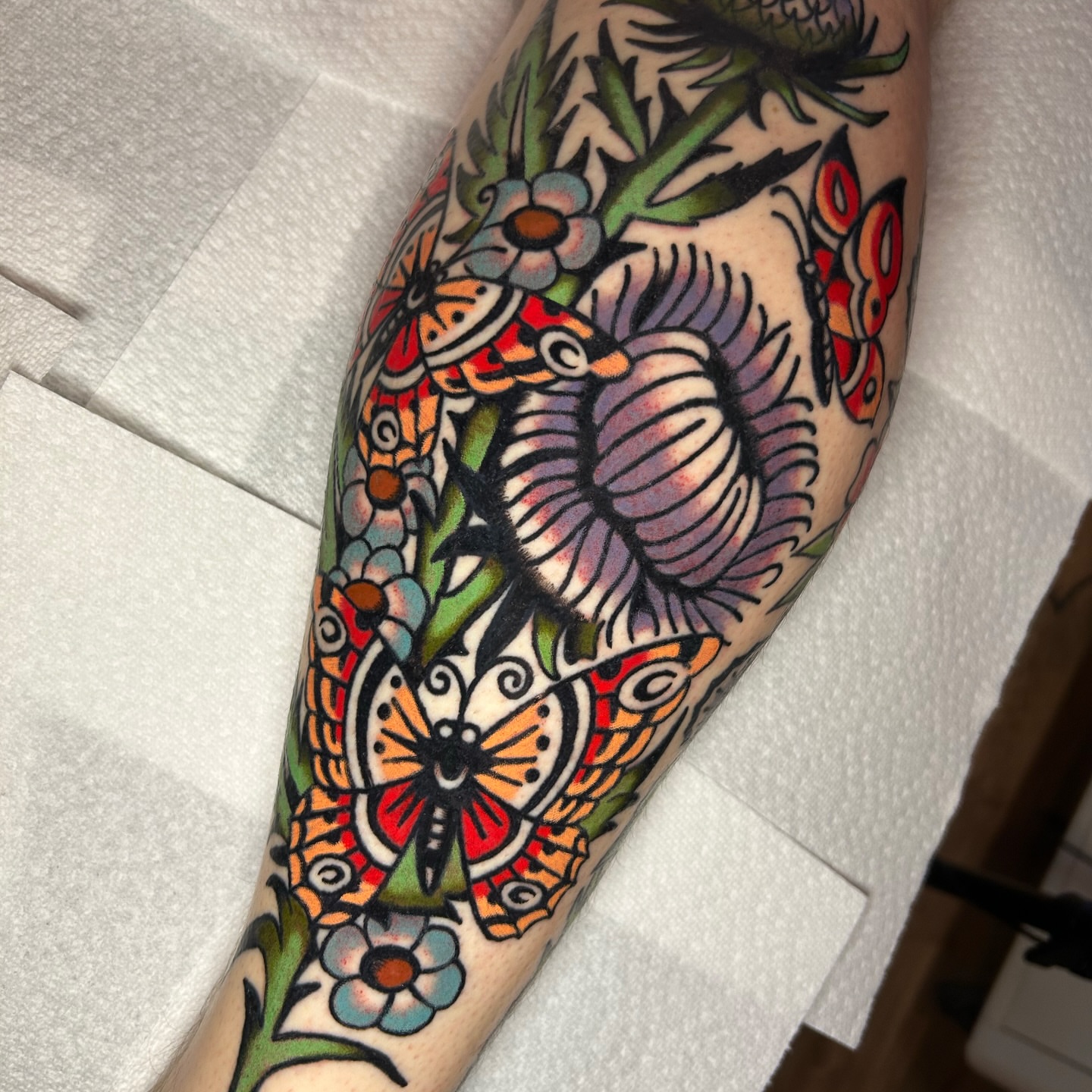 Butterflies and flowers American traditional tattoo on the forearm by Mitch Hoggard