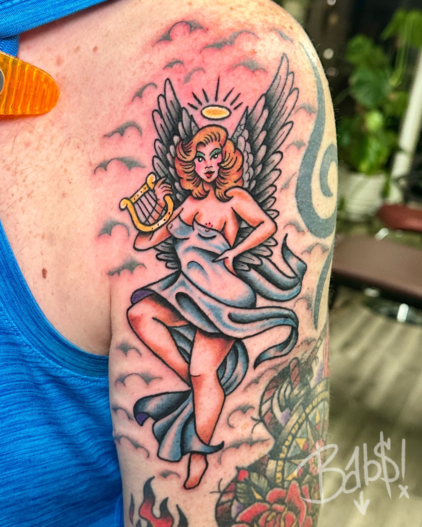 Angel with harp American traditional tattoo on the upper arm by Justin B