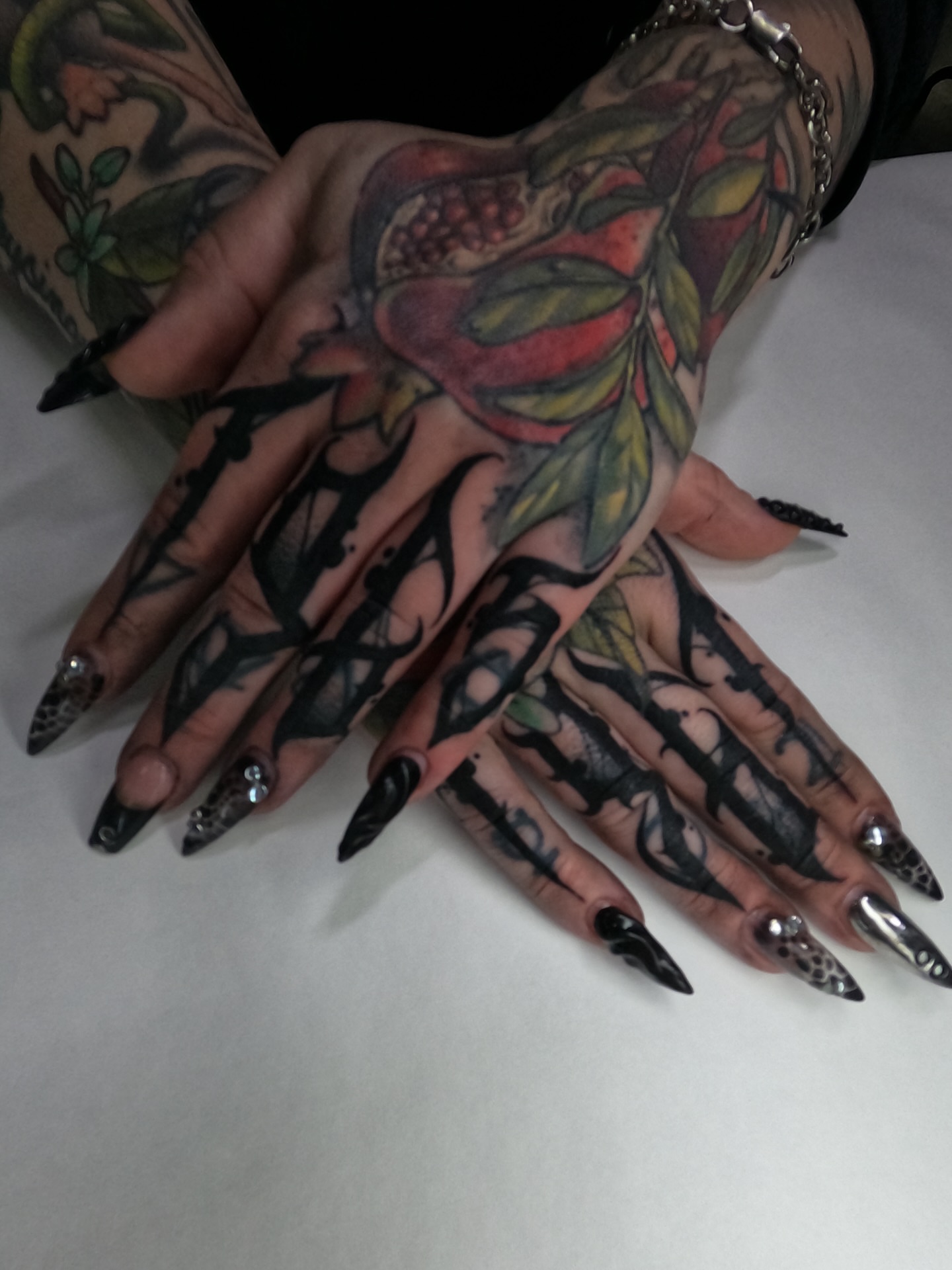 Pomegranate and leaves neo-traditional tattoo on the hand by S C A B B e R W O C K y