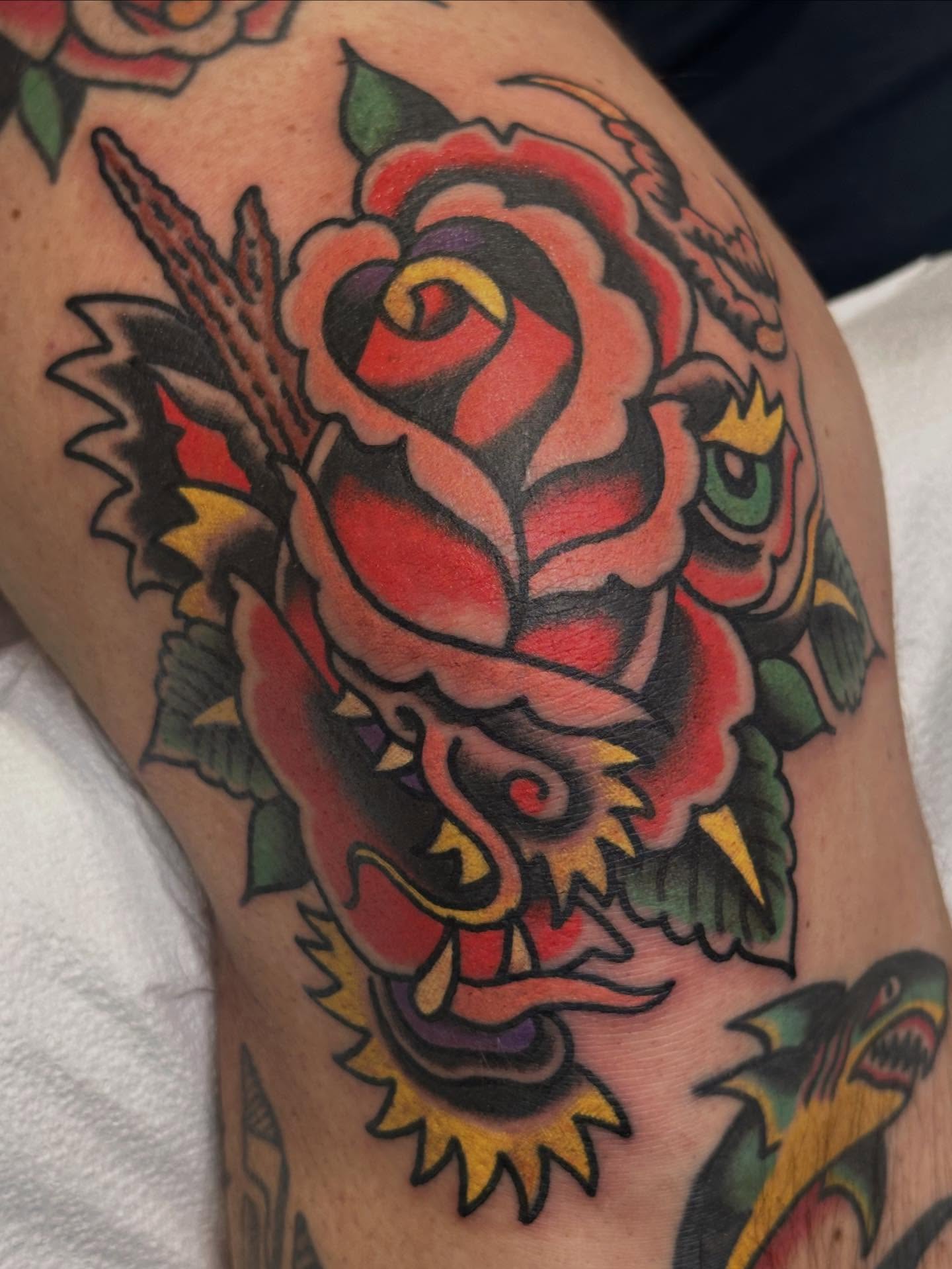 Rose and dragon American traditional tattoo on the thigh by Cody Woolard, Seymour, Tennessee