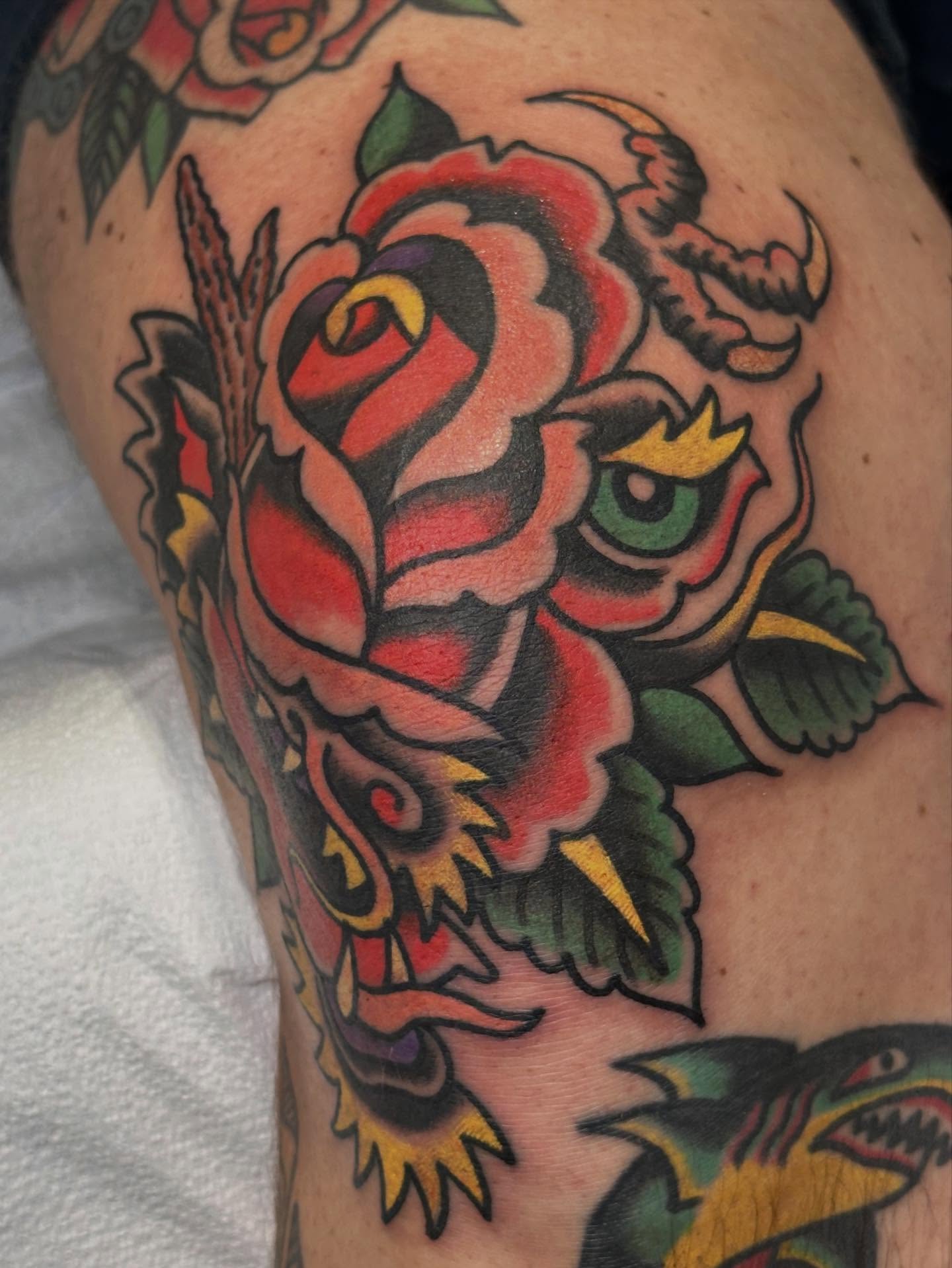 Rose and dragon American traditional tattoo on the thigh by Cody Woolard, Seymour, Tennessee