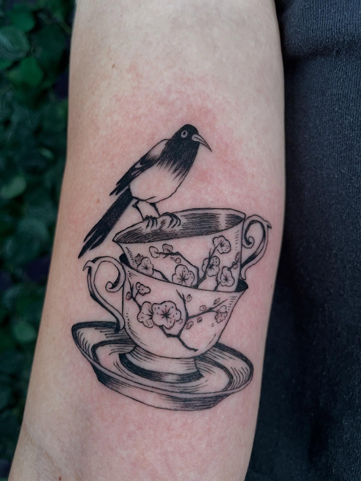 Bird perched on teacup realism tattoo on the forearm by cindy ha soul son
