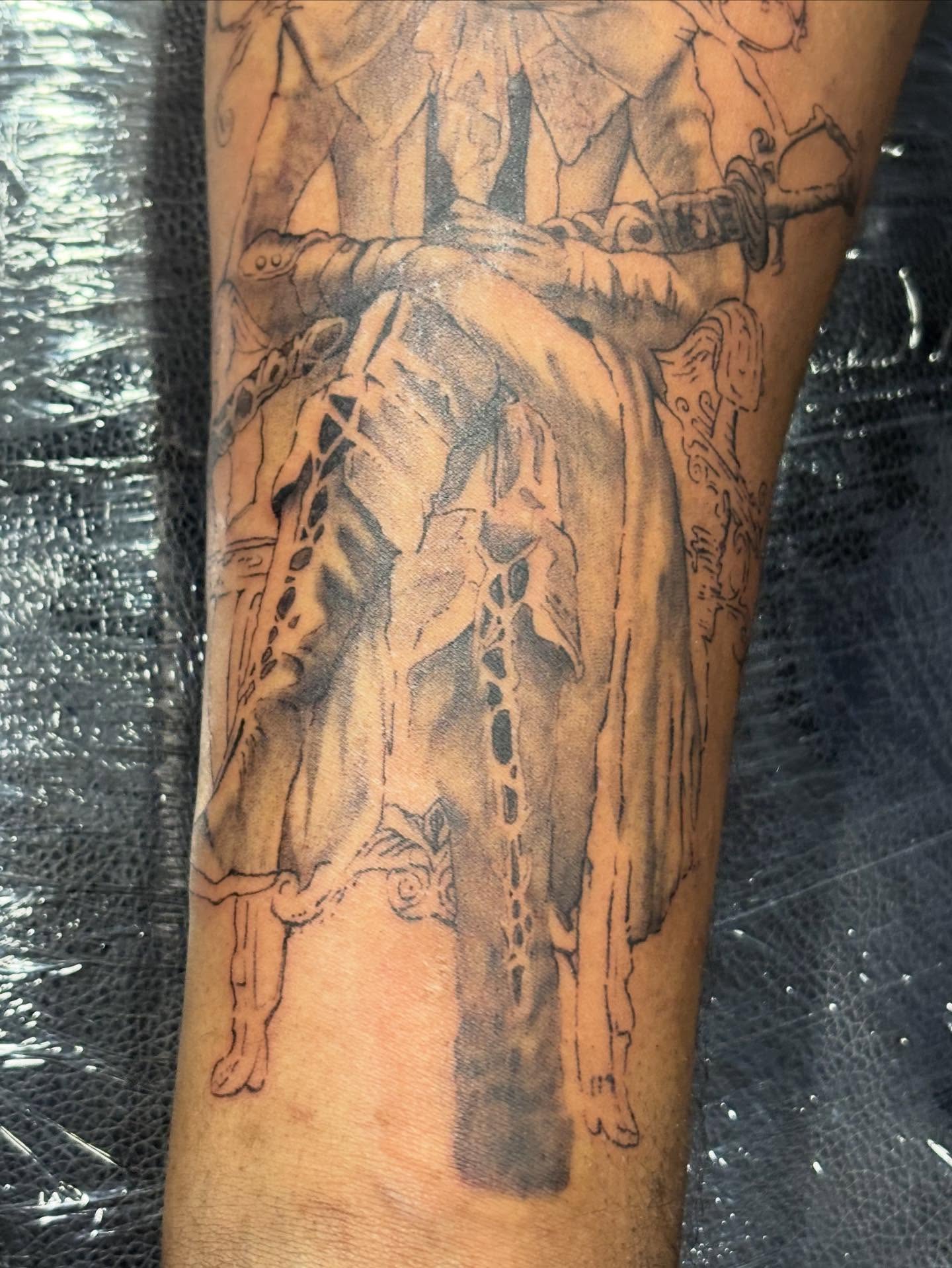 Horse and rider black and grey tattoo on the forearm by Slade Nowicki