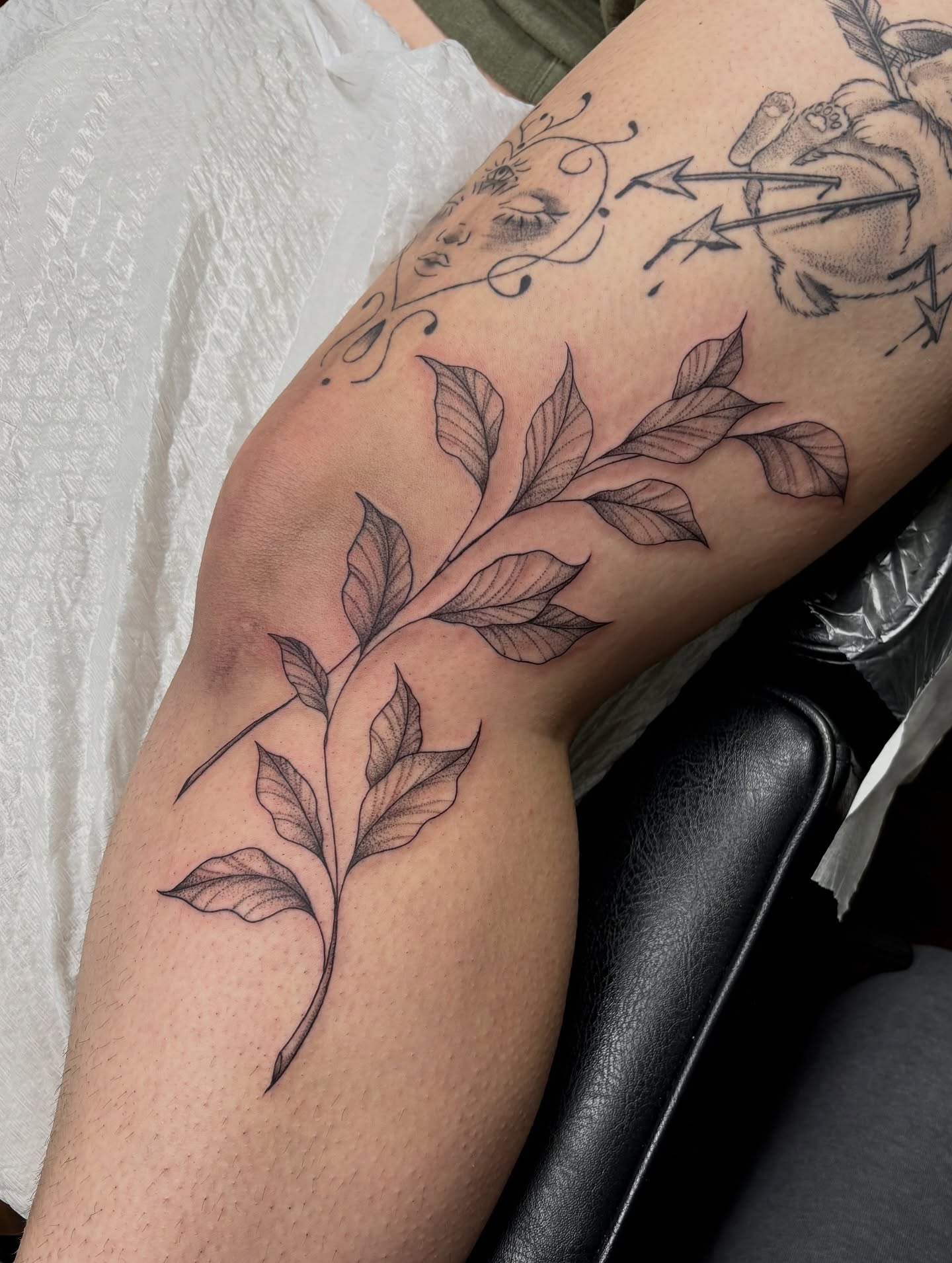 Branch with leaves black and grey tattoo on the forearm by sydney honn