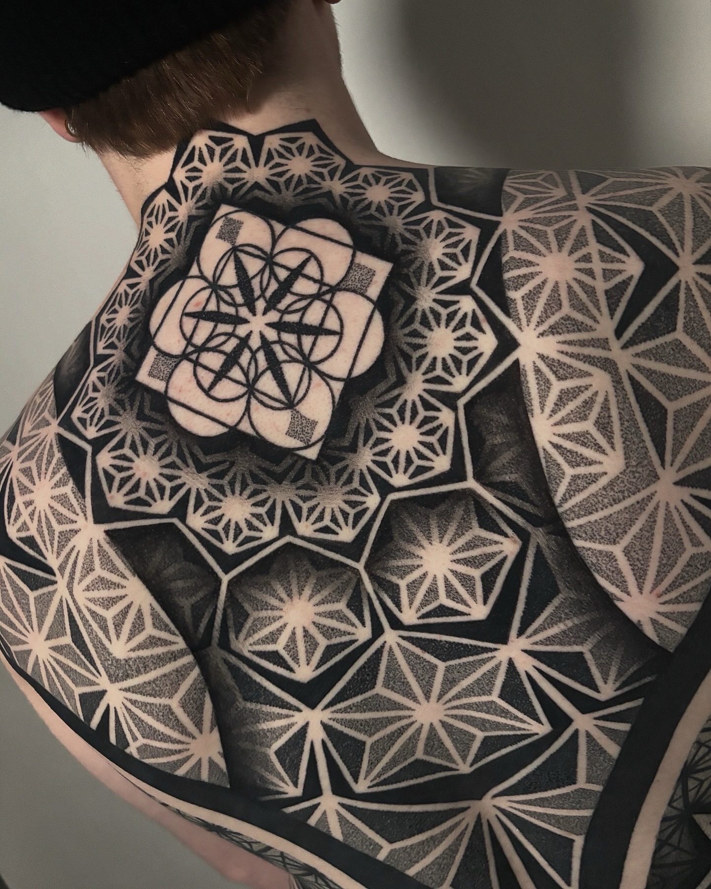 Geometric pattern geometric tattoo on the back by Mitch Koch