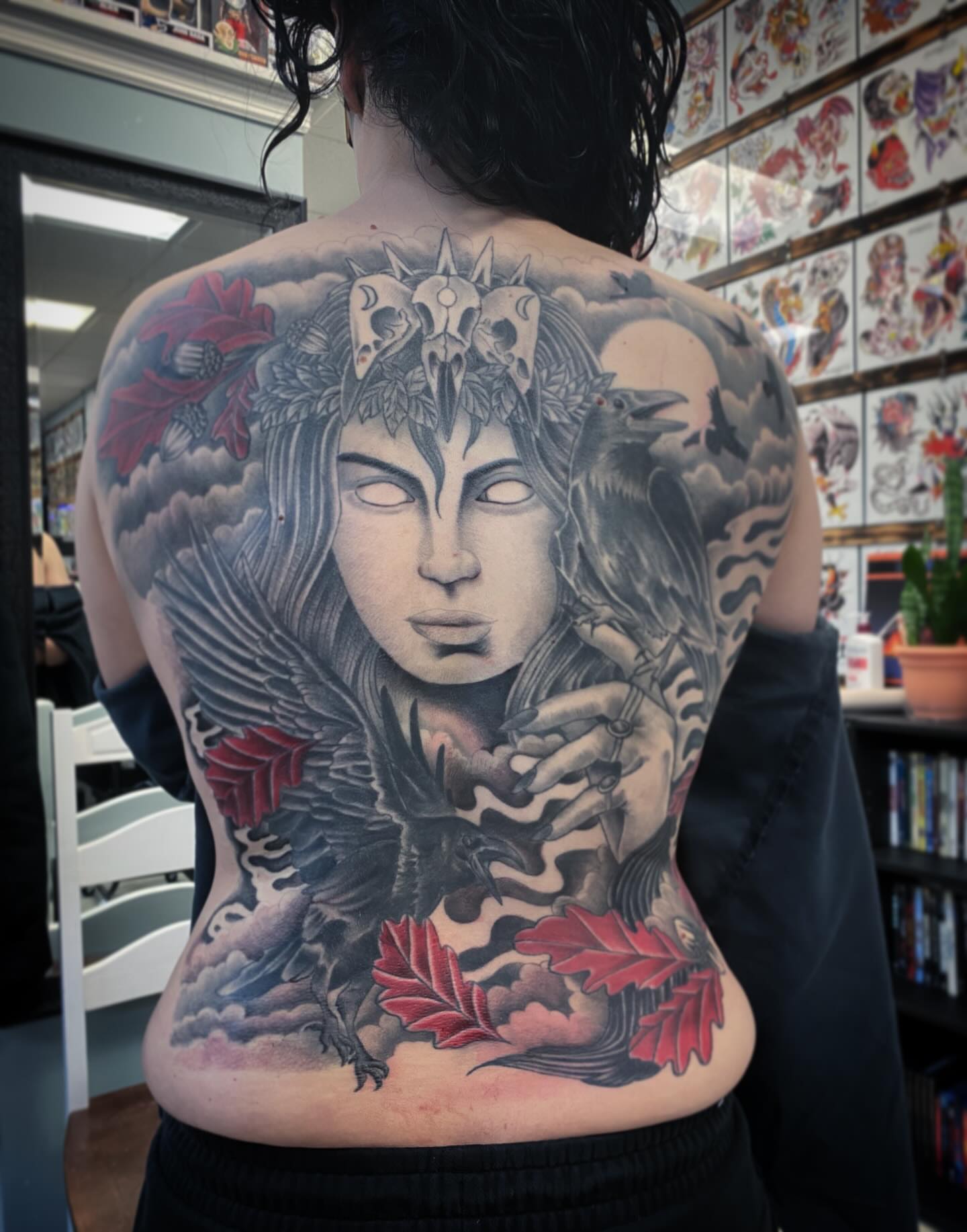 Woman with crow realism tattoo on the back by Kyle Mitchell, Cincinnati